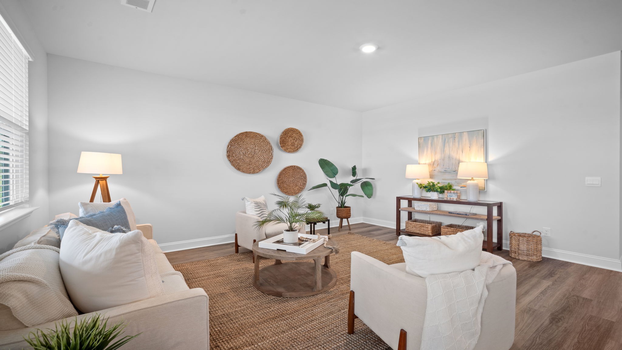 Living area of home decorated with seating and tables