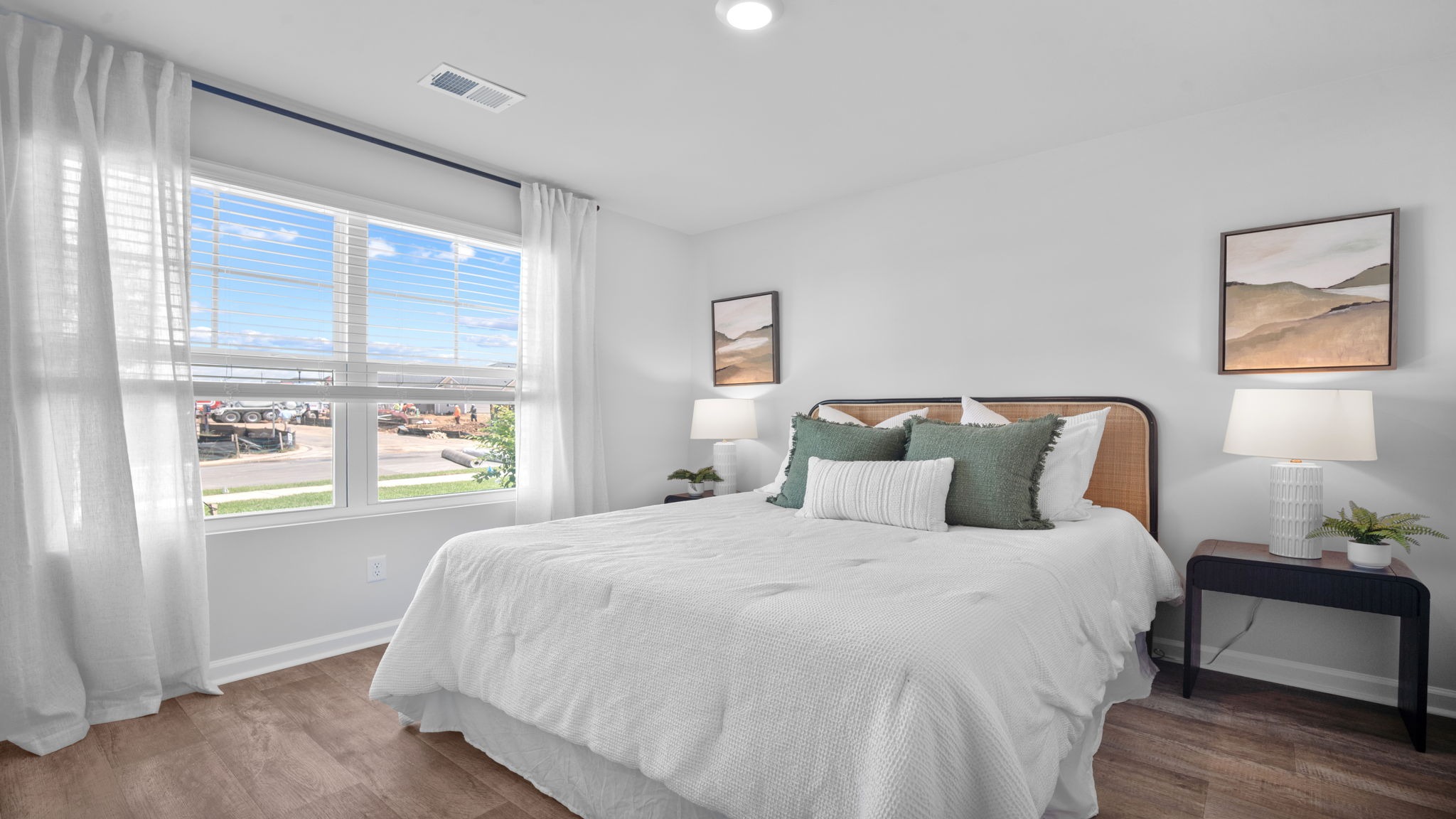 Guest bedroom decorated with a bed and side table