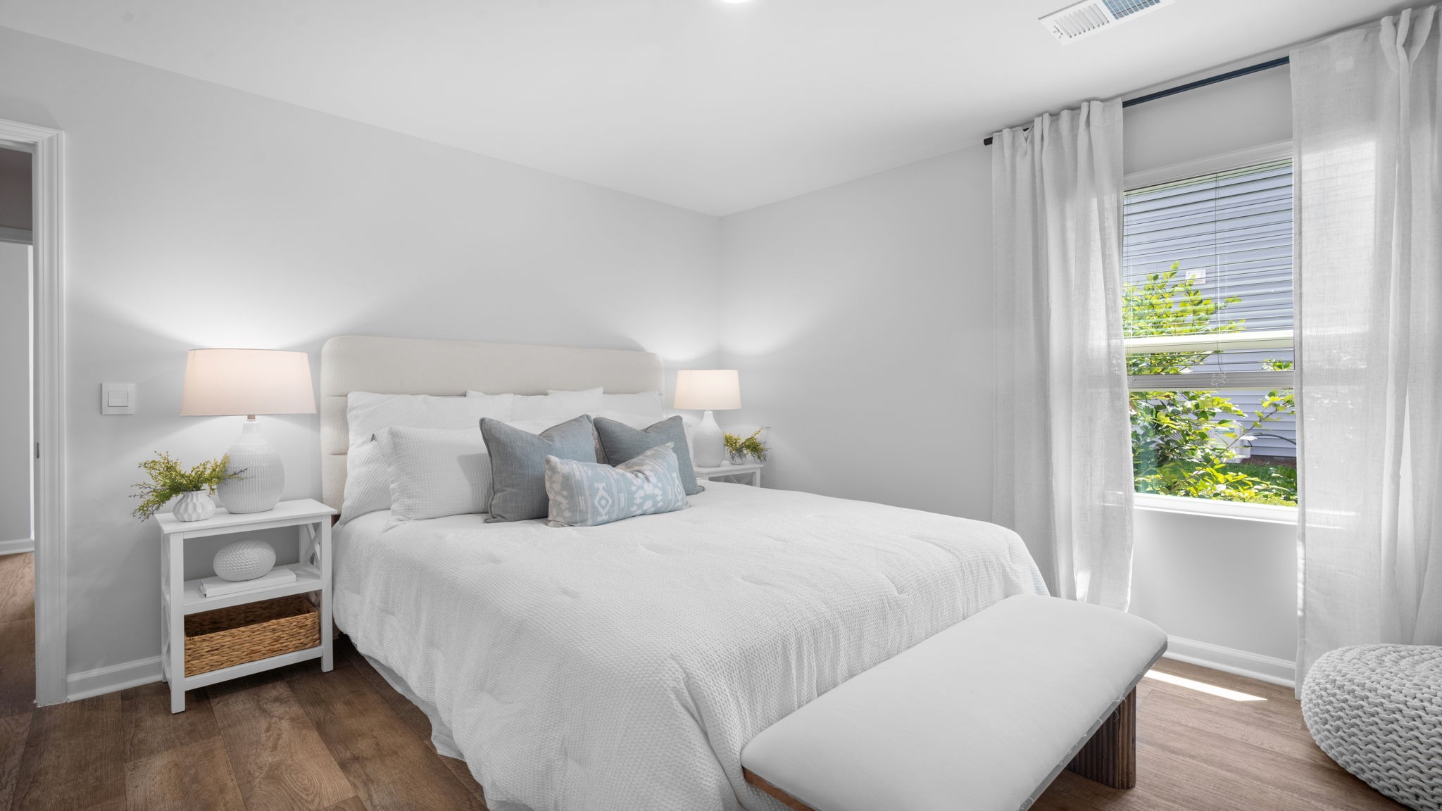 Guest bedroom decorated with a bed and side table