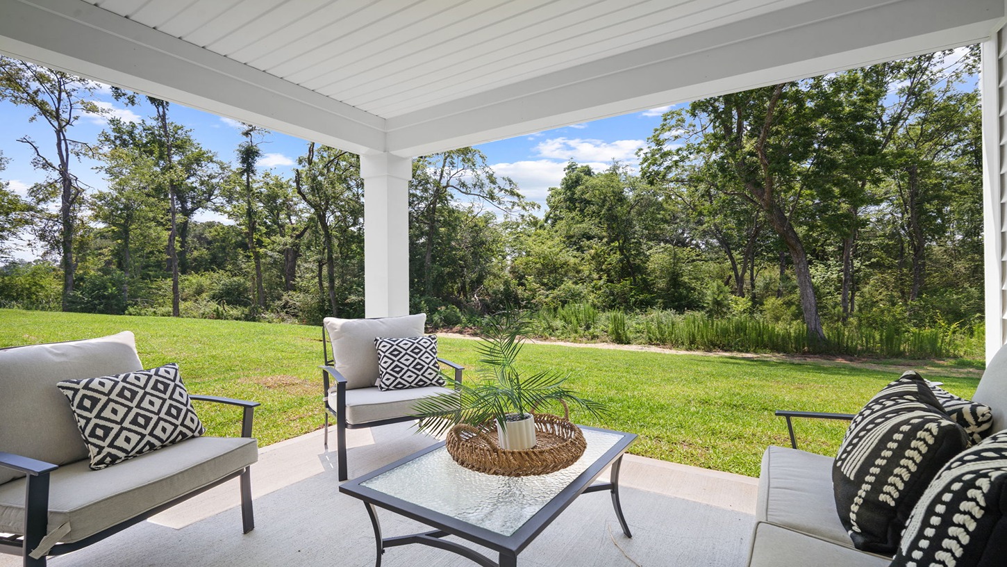 Rear covered patio decorated with seating and a table