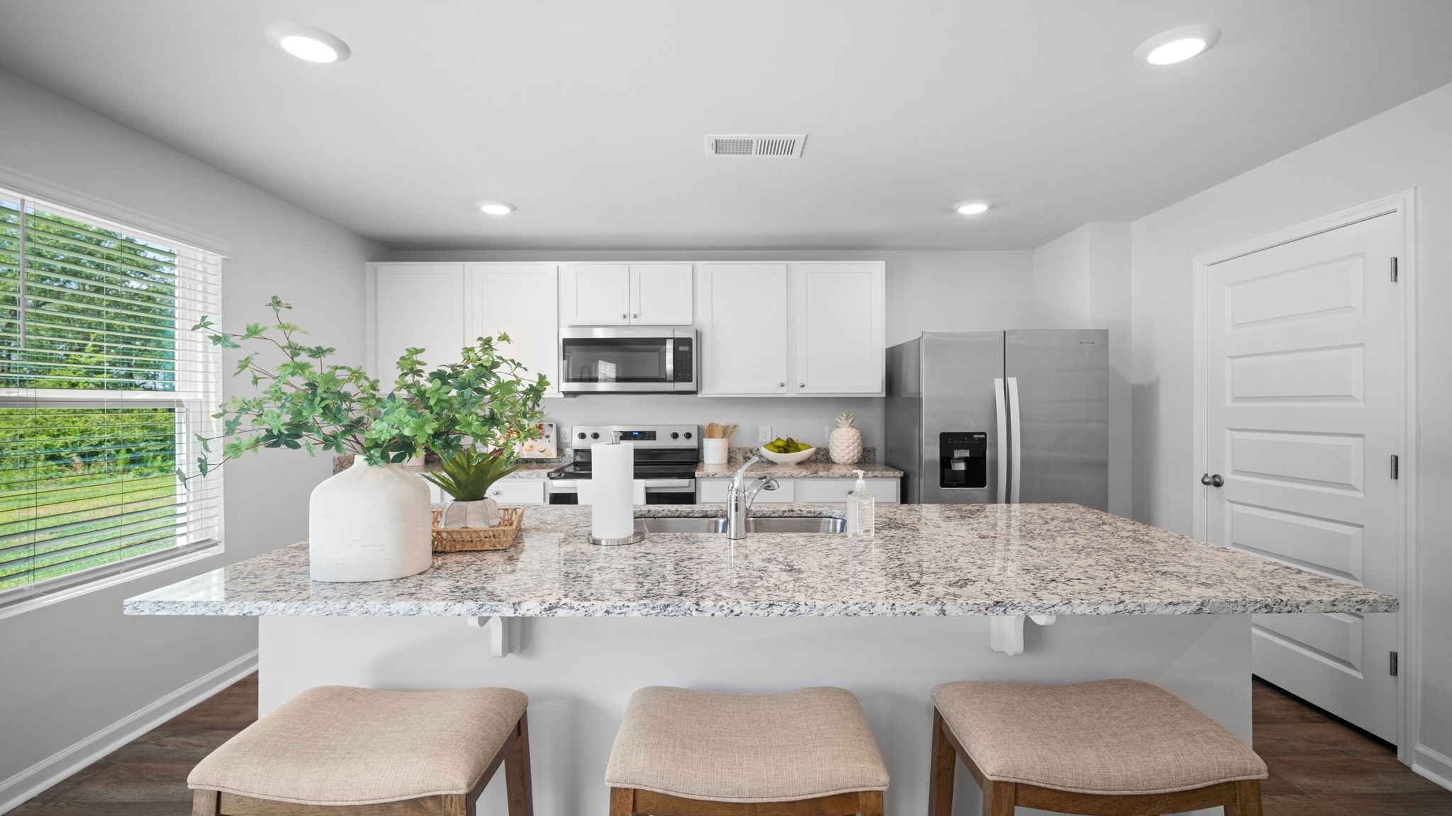 Open-concept kitchen overlooking dining and family room, perfect for entertaining and everyday living.