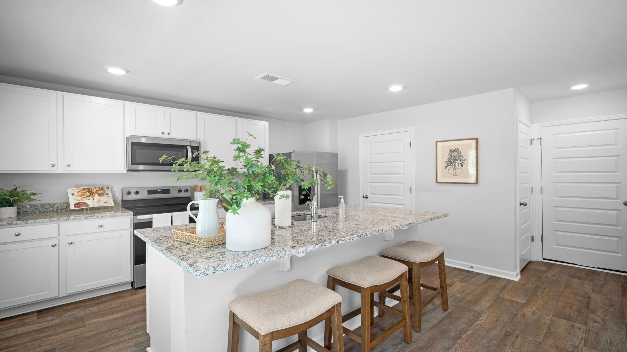 Large center island with seating, prep space, and storage at the heart of the Belhaven floor plan.