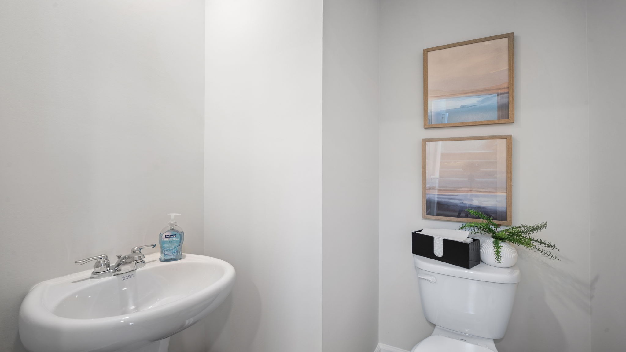 Convenient first-floor powder room with modern fixtures and designer-inspired finishes.