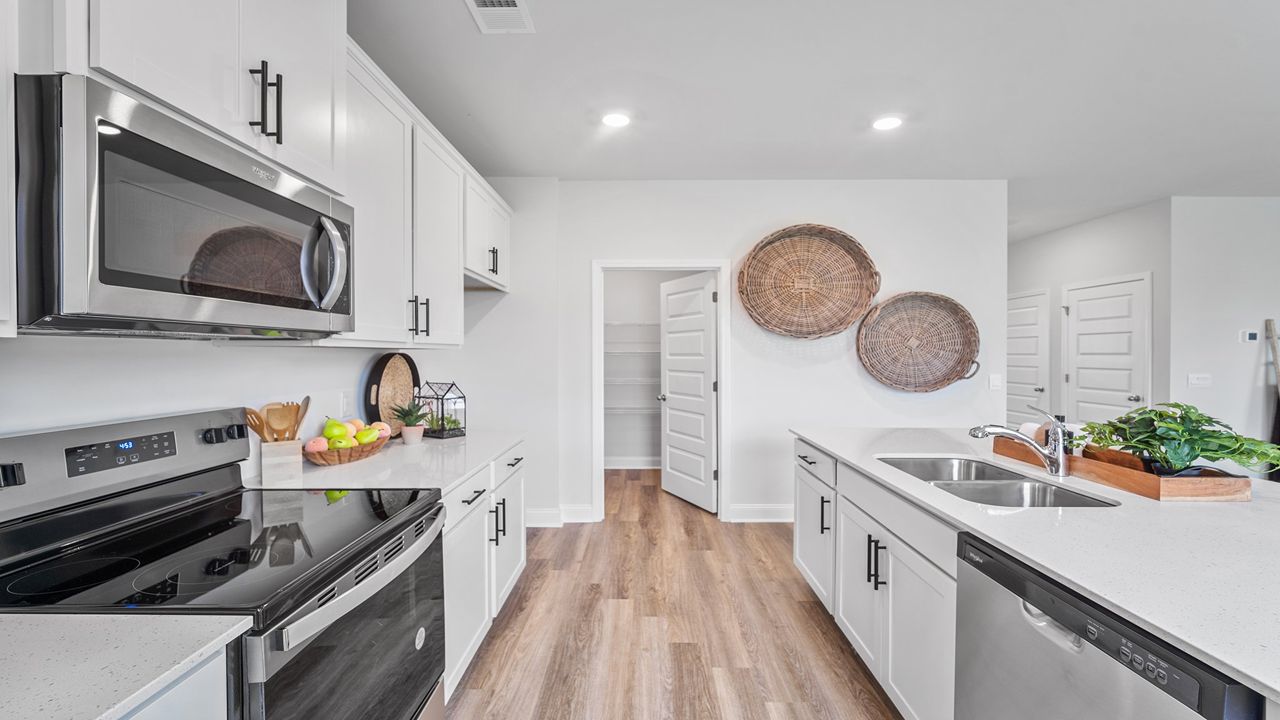 Open-concept kitchen overlooking dining and family room, perfect for entertaining guests.