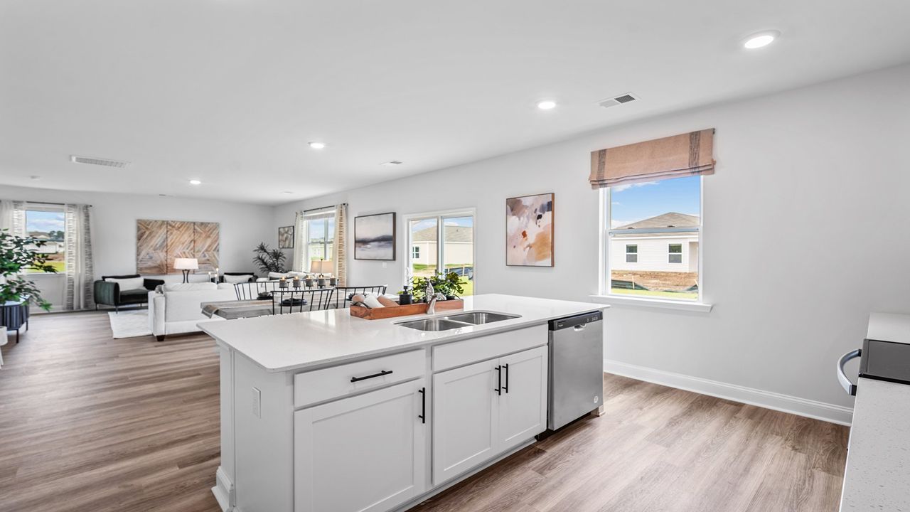 Oversized kitchen island serving as the focal point of this open-concept home.