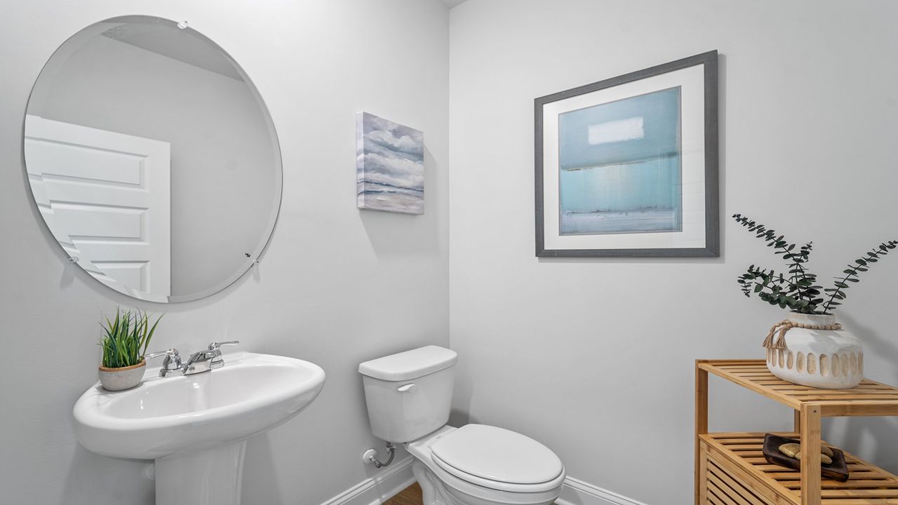 Convenient first-floor powder room with modern fixtures and stylish finishes.