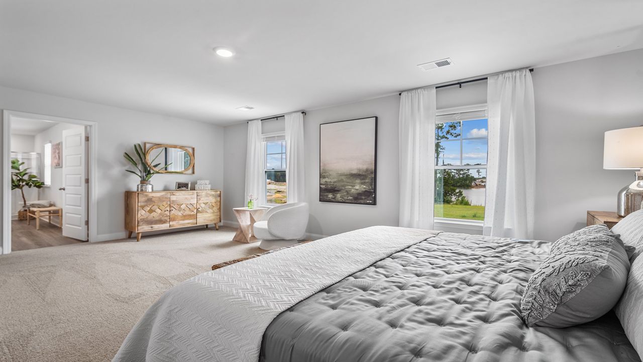 Spacious owner's bedroom featuring elegant finishes and abundant natural light.