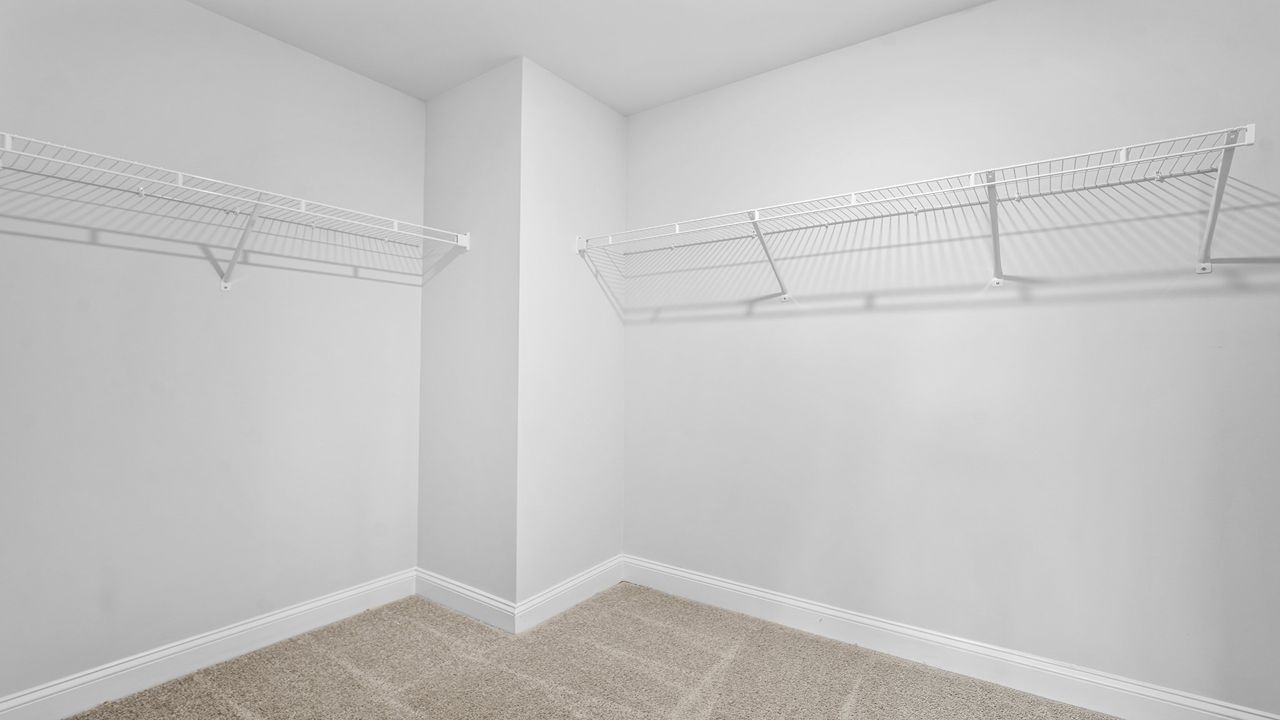 Expansive walk-in closet providing exceptional storage and organization in the owner's suite.