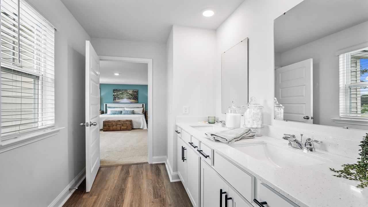Spa-inspired owner's bathroom featuring dual vanities, walk-in shower, and contemporary finishes.