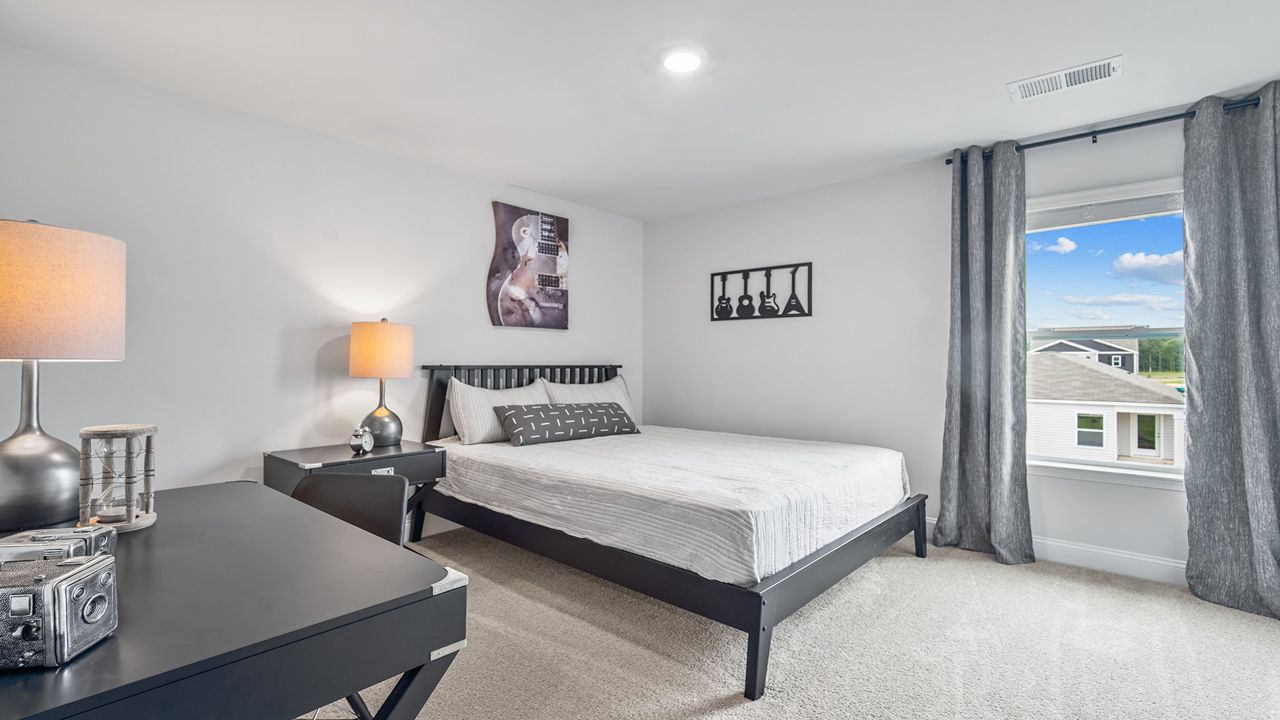 Bright guest bedroom with generous closet space and versatile living options.