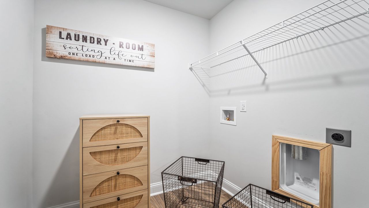 Dedicated upstairs laundry room offering convenience, organization, and efficiency.