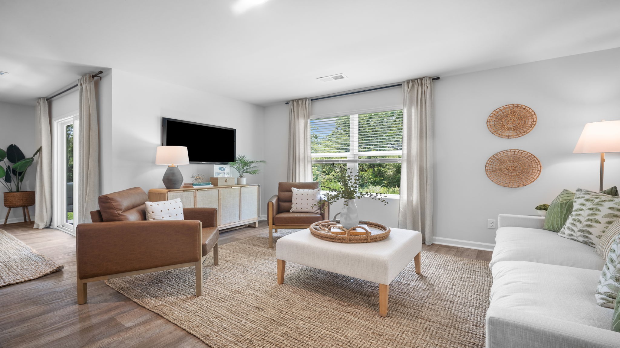 Spacious family room in the Cali floor plan featuring an open layout, natural light, and direct access to the kitchen and dining areas.