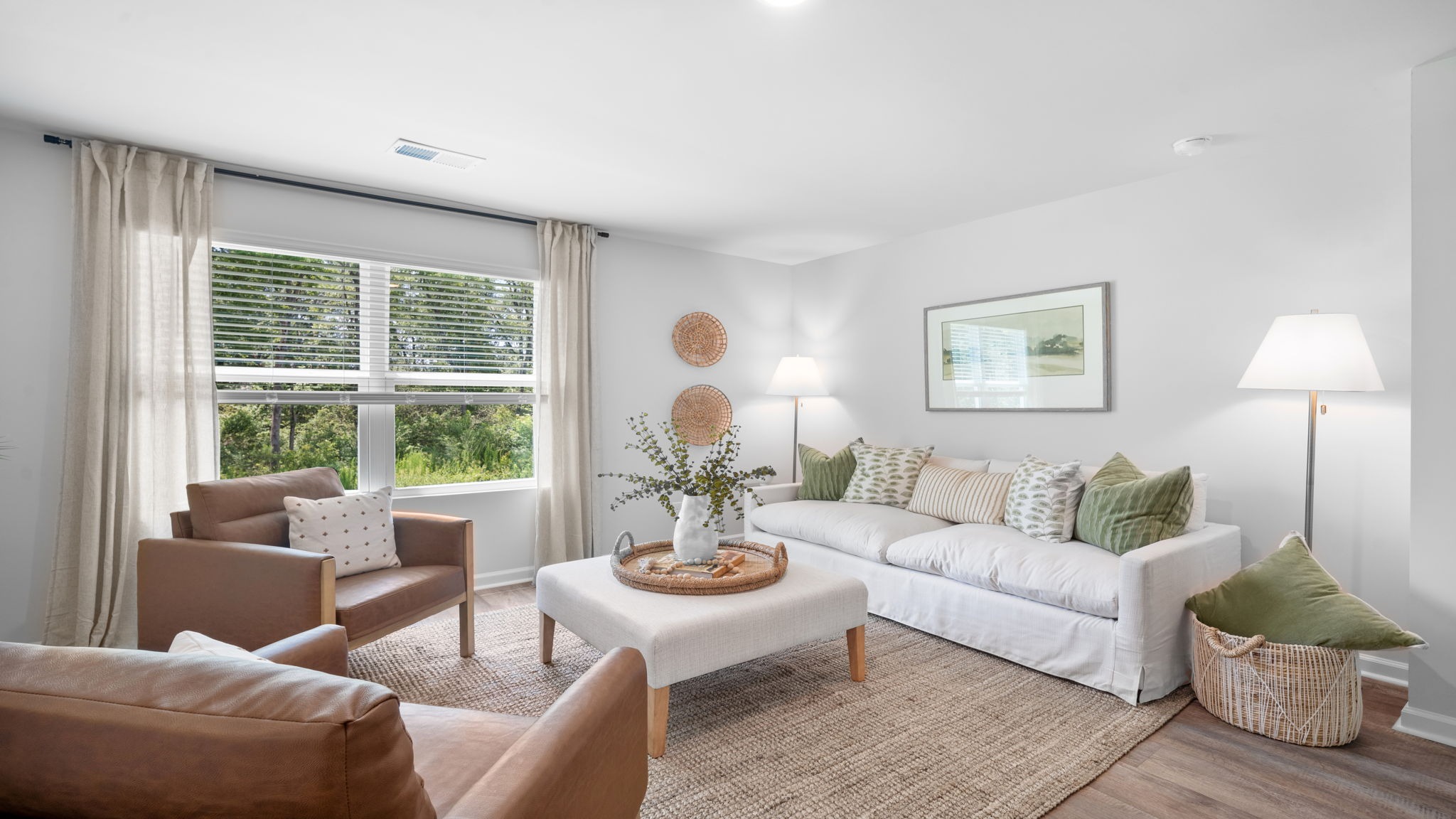 Open-concept living room in the Cali floor plan featuring abundant natural light, spacious gathering areas, and seamless flow to the kitchen and dining room.