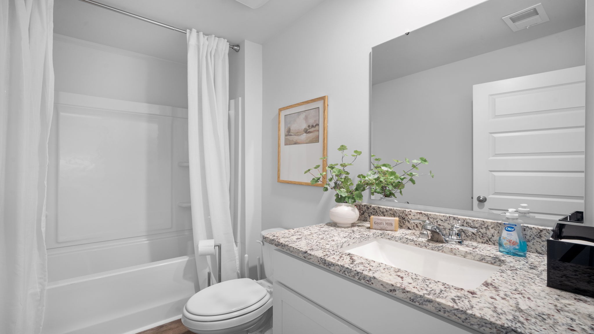 Stylish guest bathroom in the Cali floor plan featuring a modern vanity, quality finishes, and convenient access from secondary bedrooms.