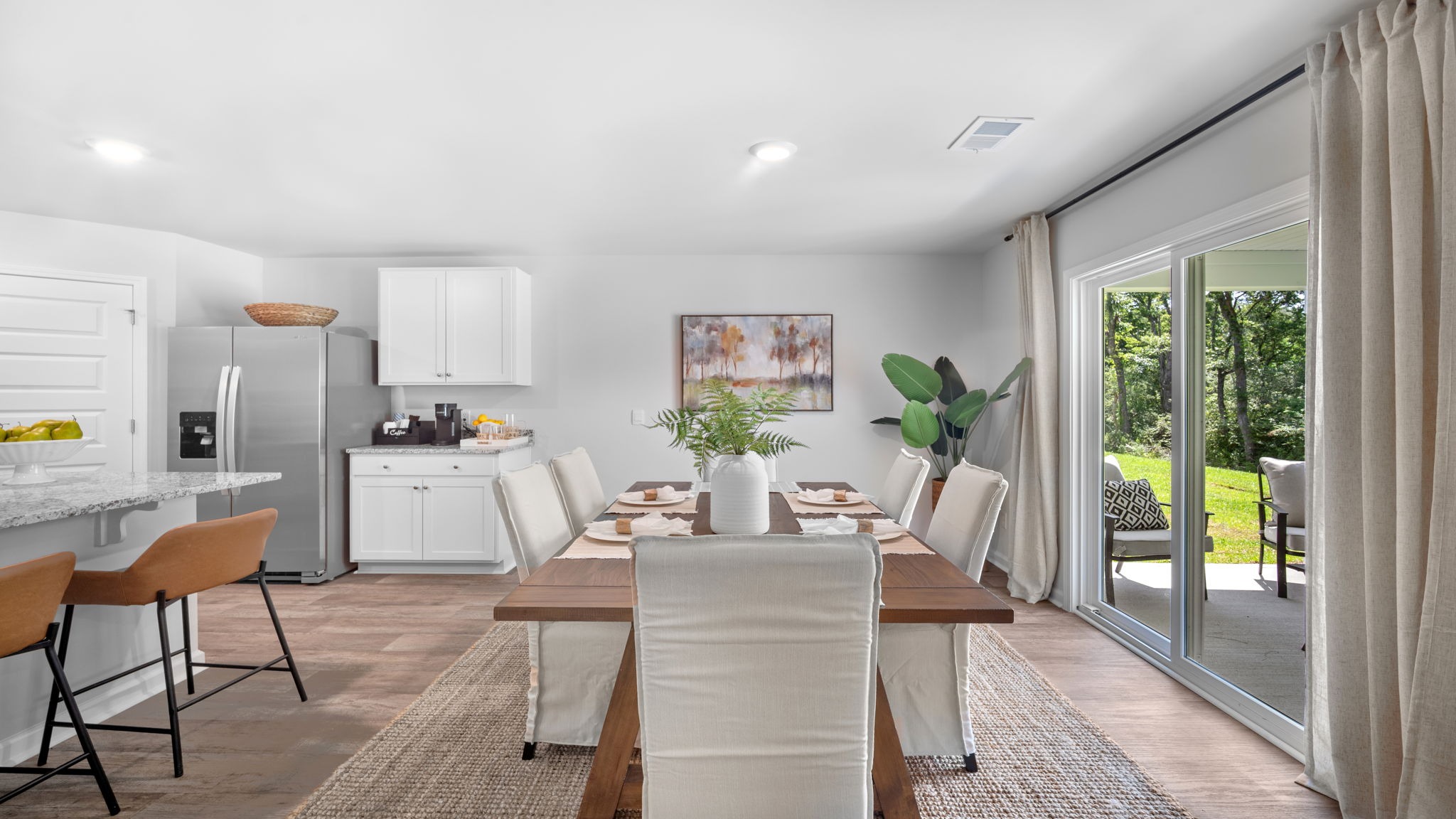 Bright dining space in the Cali home offering seamless flow between living areas and modern open-concept design.