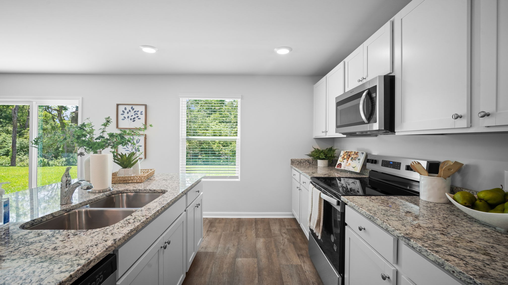 Bright gourmet kitchen in the Belhaven floor plan offering stylish finishes, ample counter space, and open dining access.