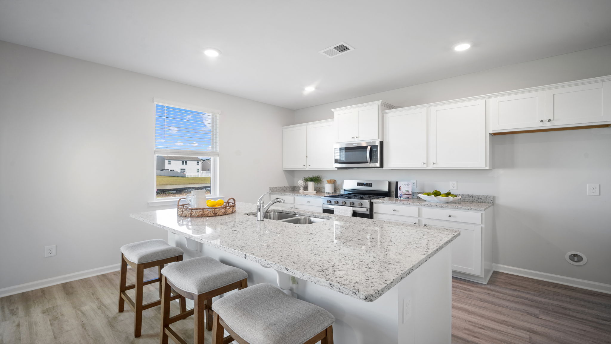 Modern Galen kitchen with spacious island seating, stylish finishes, pantry storage, and seamless flow into the dining and living areas.