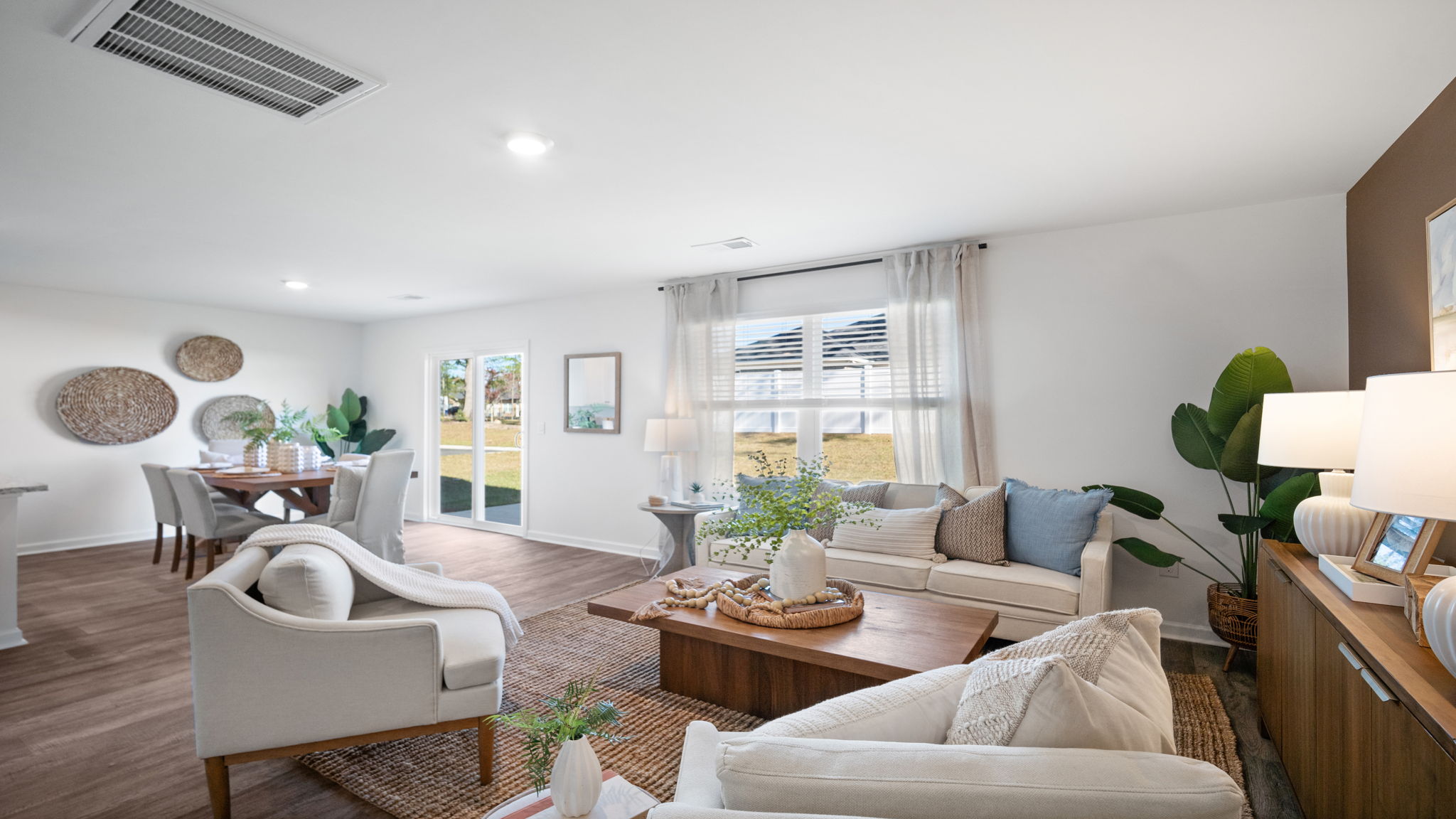 Inviting living room in the Hayden home offering modern finishes, expansive living areas, and direct access to the kitchen and dining room.