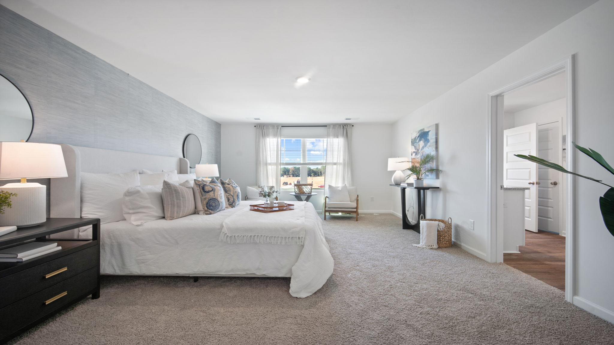 Private primary suite in the Hayden floor plan featuring a spacious bedroom, large windows, and a relaxing owner's retreat atmosphere.