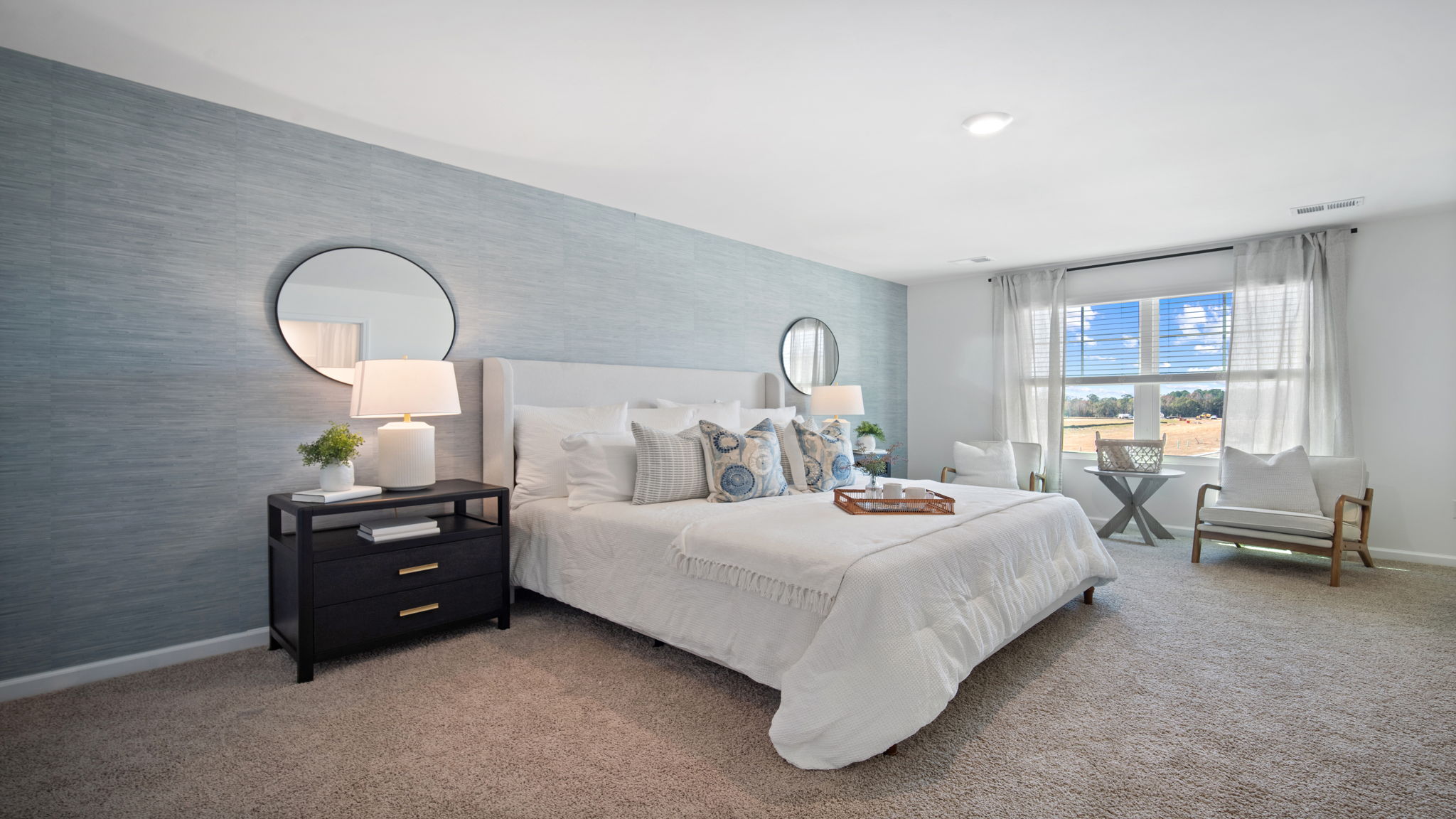 Luxurious primary bedroom in the Hayden home offering comfort, privacy, and stylish design details.