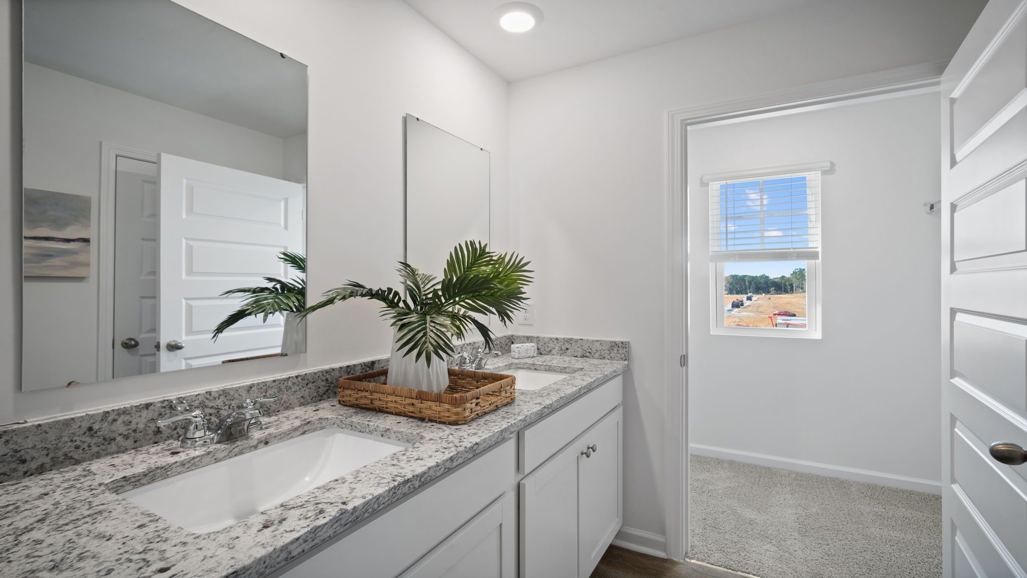 Spa-inspired primary bathroom in the Hayden floor plan featuring dual vanities, a walk-in shower, modern fixtures, and generous storage space.