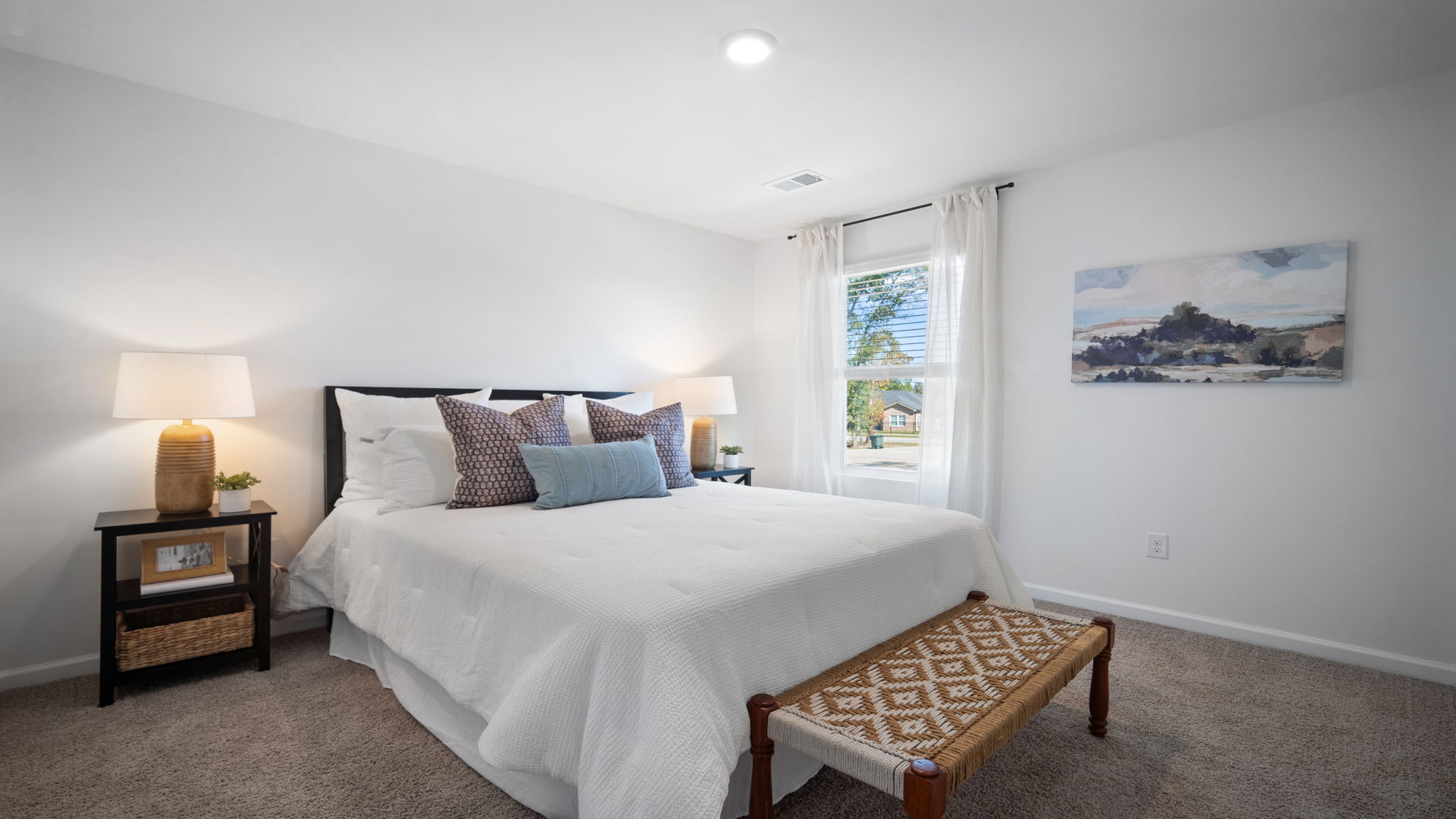 Bright secondary bedroom in the Hayden home offering modern finishes, generous closet space, and privacy for family or guests.