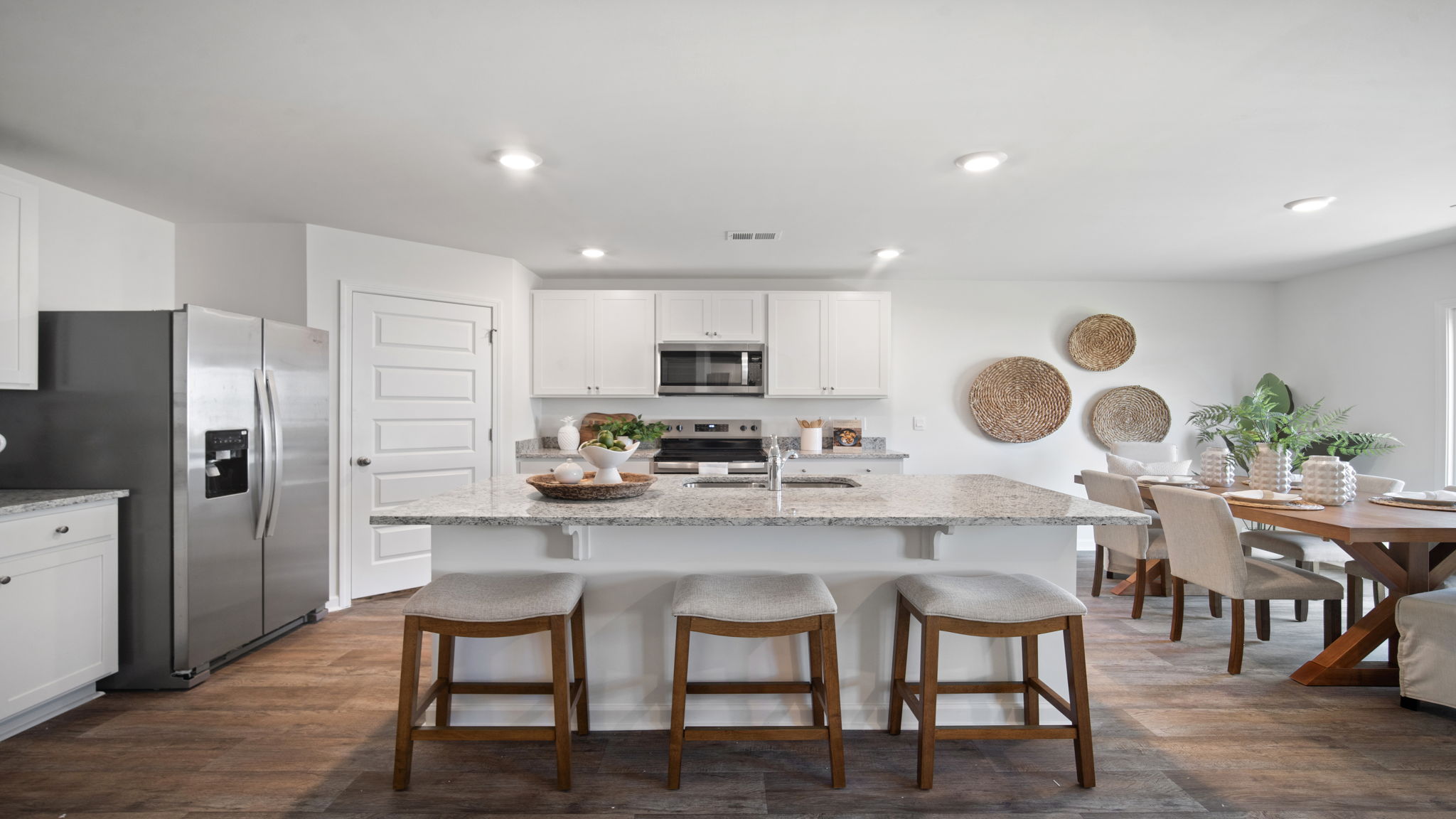 Modern Hayden kitchen with spacious island seating, stylish finishes, pantry storage, and seamless flow into the dining and living areas.