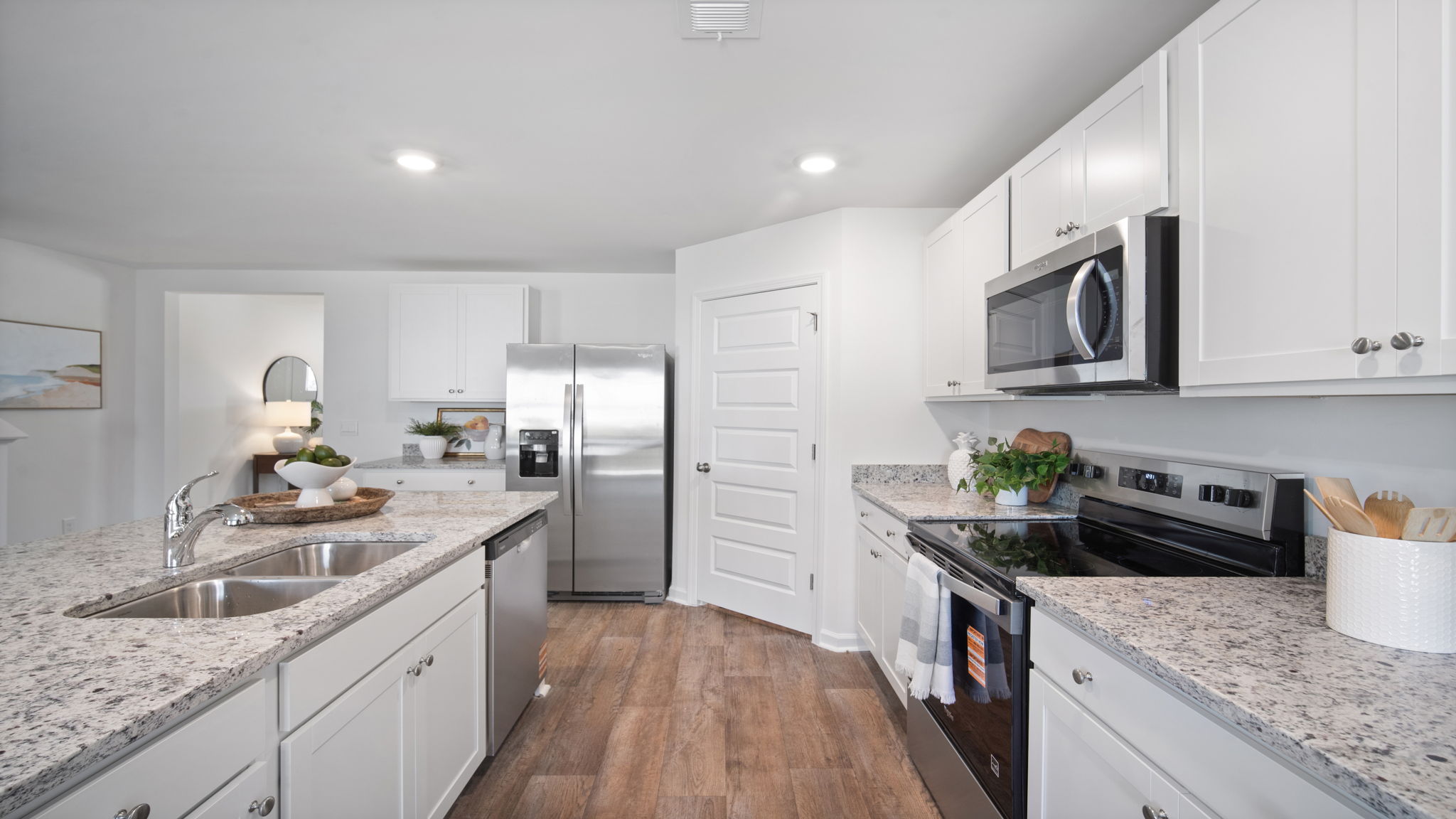 Bright gourmet kitchen in the Hayden home designed for entertaining with ample counter space and open views of the family room.