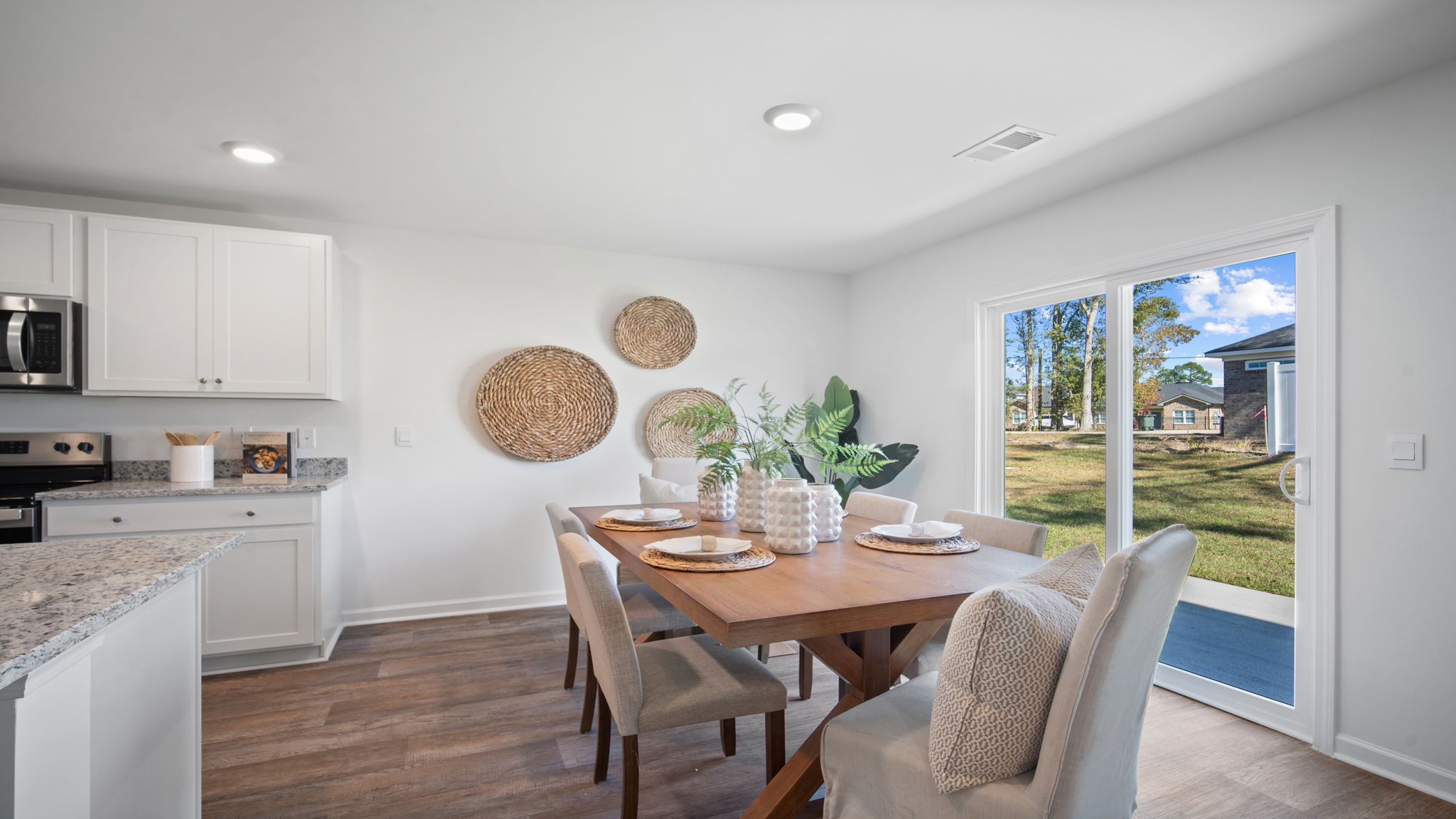 Elegant dining area in the Hayden floor plan featuring open sightlines, modern lighting, and convenient access to the kitchen and family room.