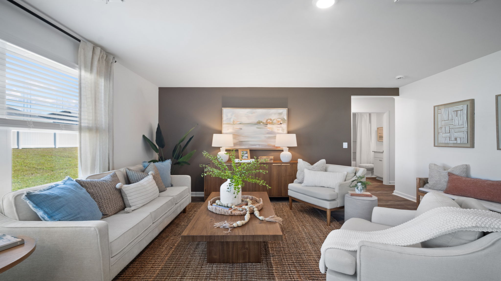Spacious family room in the Hayden floor plan featuring abundant natural light, open-concept design, and comfortable gathering space for family and guests.