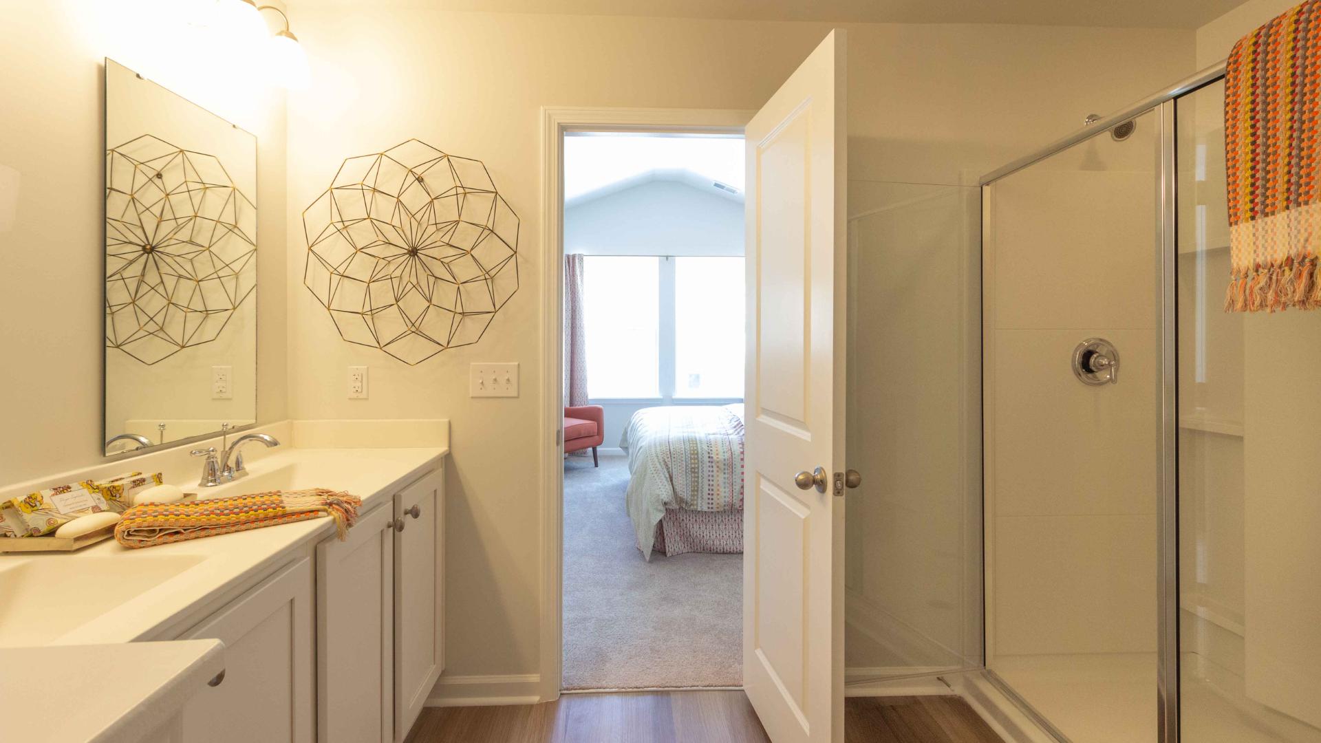 Primary Bathroom view including vanity, shower enclosure, and bedroom visible beyond