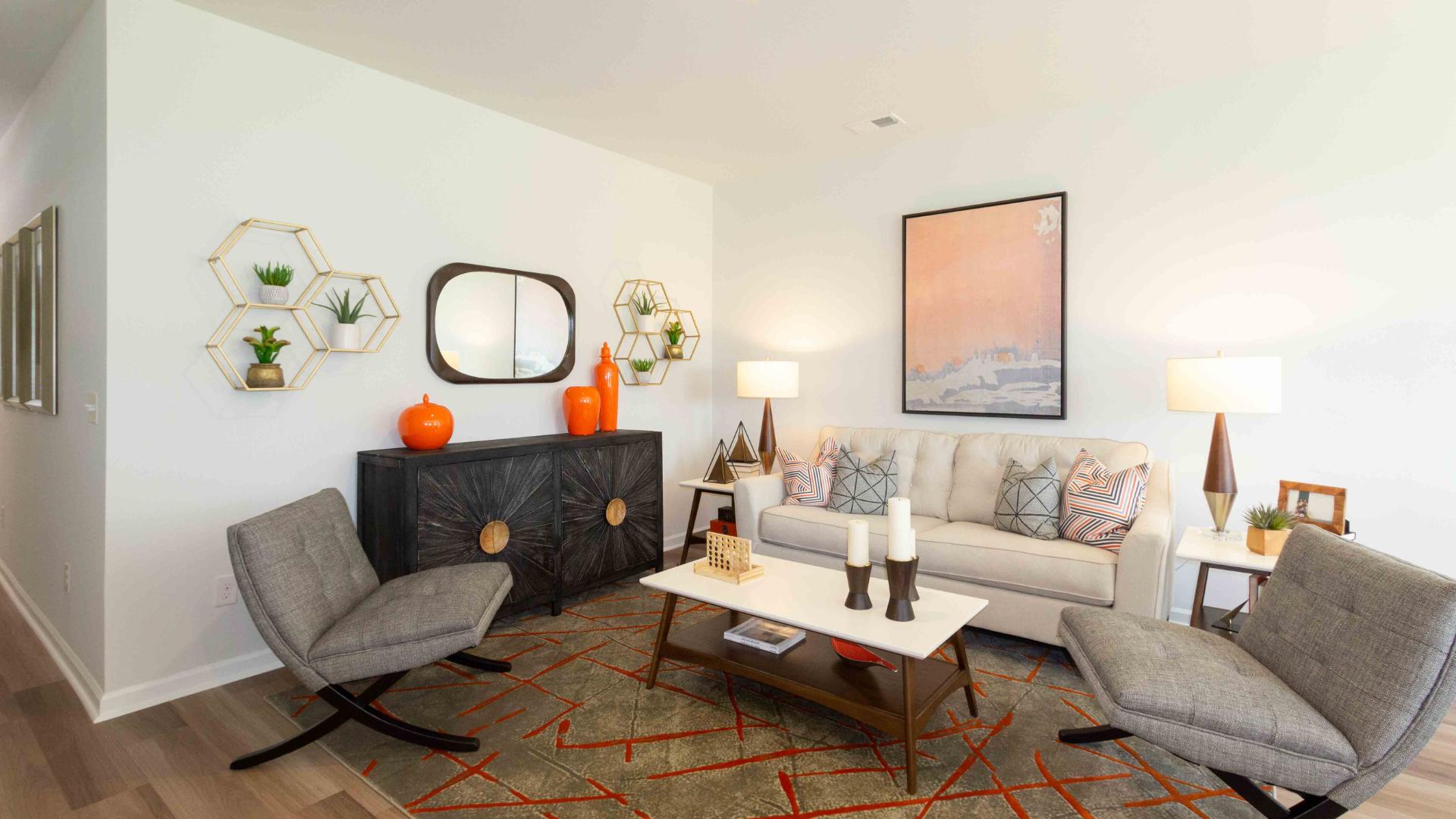 Alternate angle of the living room highlighting a fireplace wall, seating arrangement, and decor.