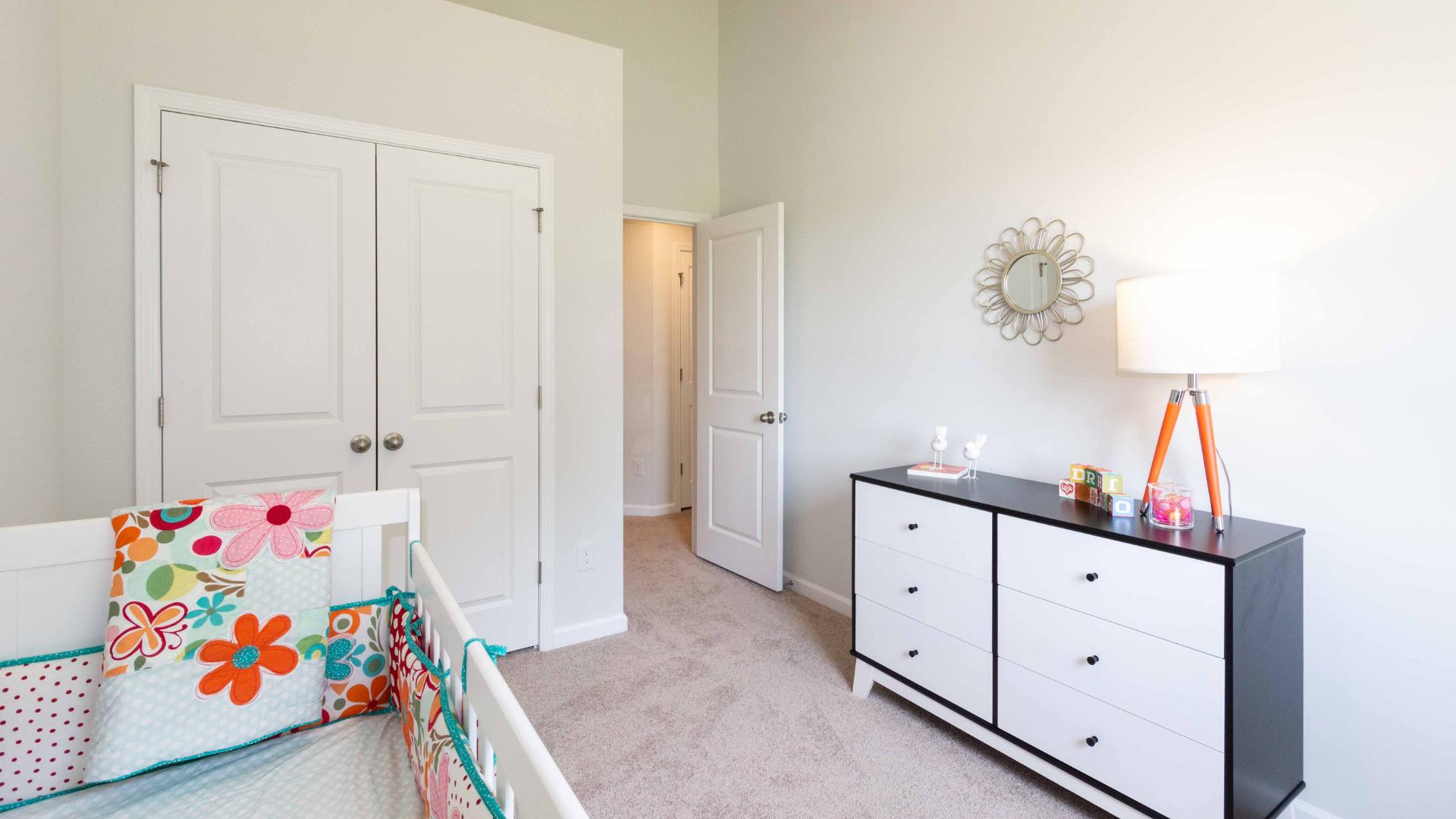 Alternate view of the nursery showing storage and furniture arrangement