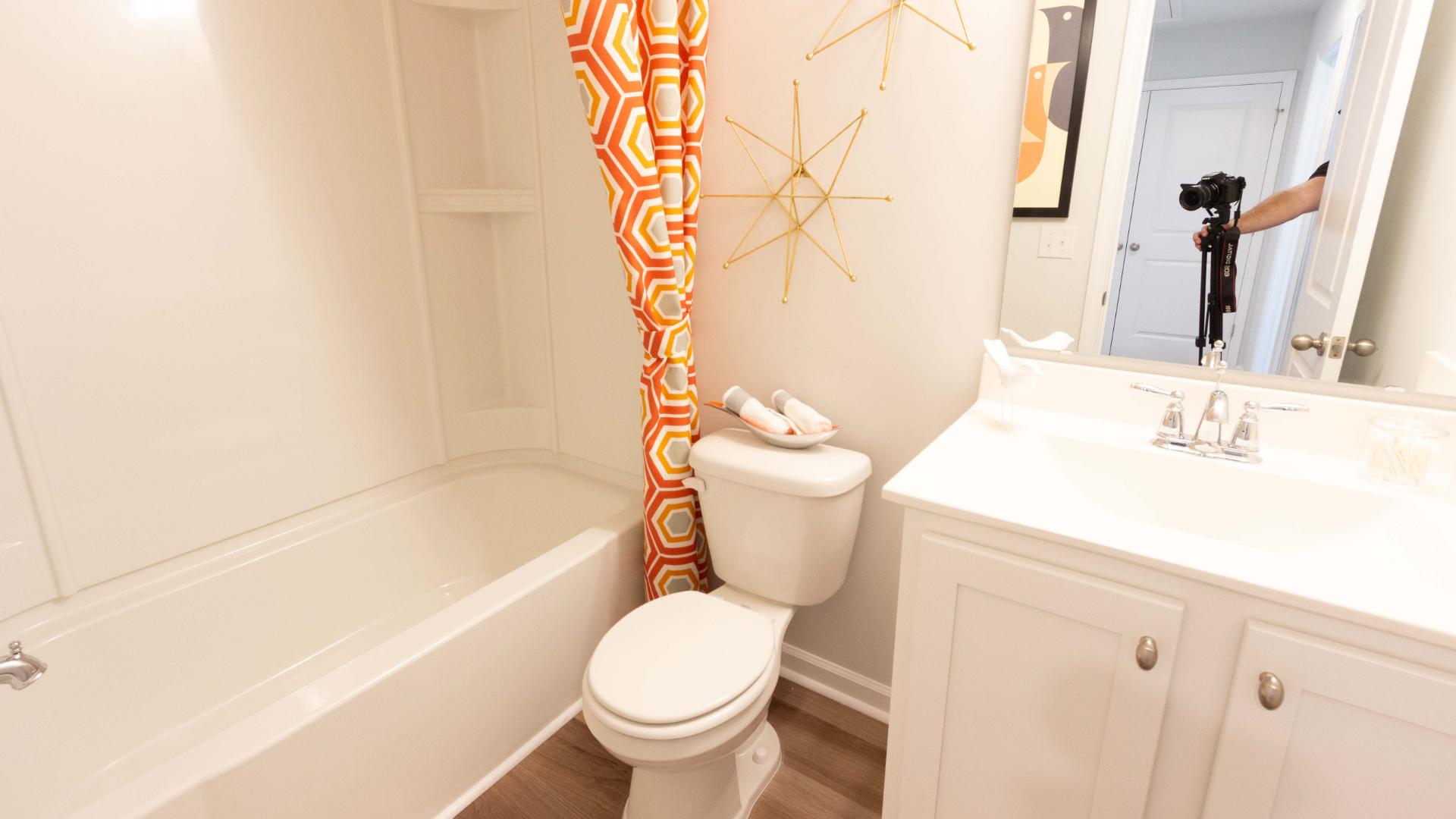 Bathroom with tub/shower combination, vanity, and decorative shower curtain