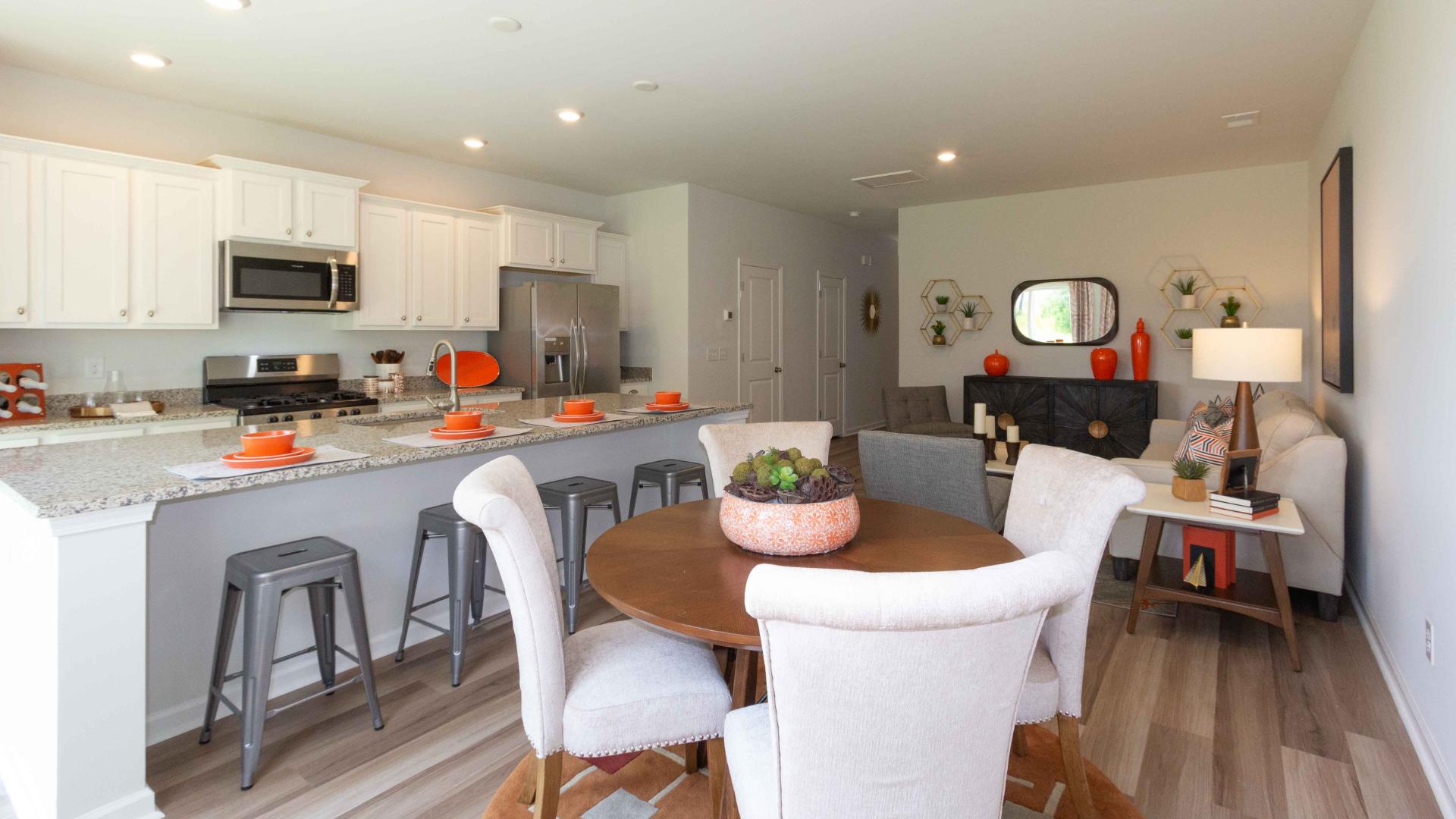View showing the transition between dining, kitchen, and living spaces.