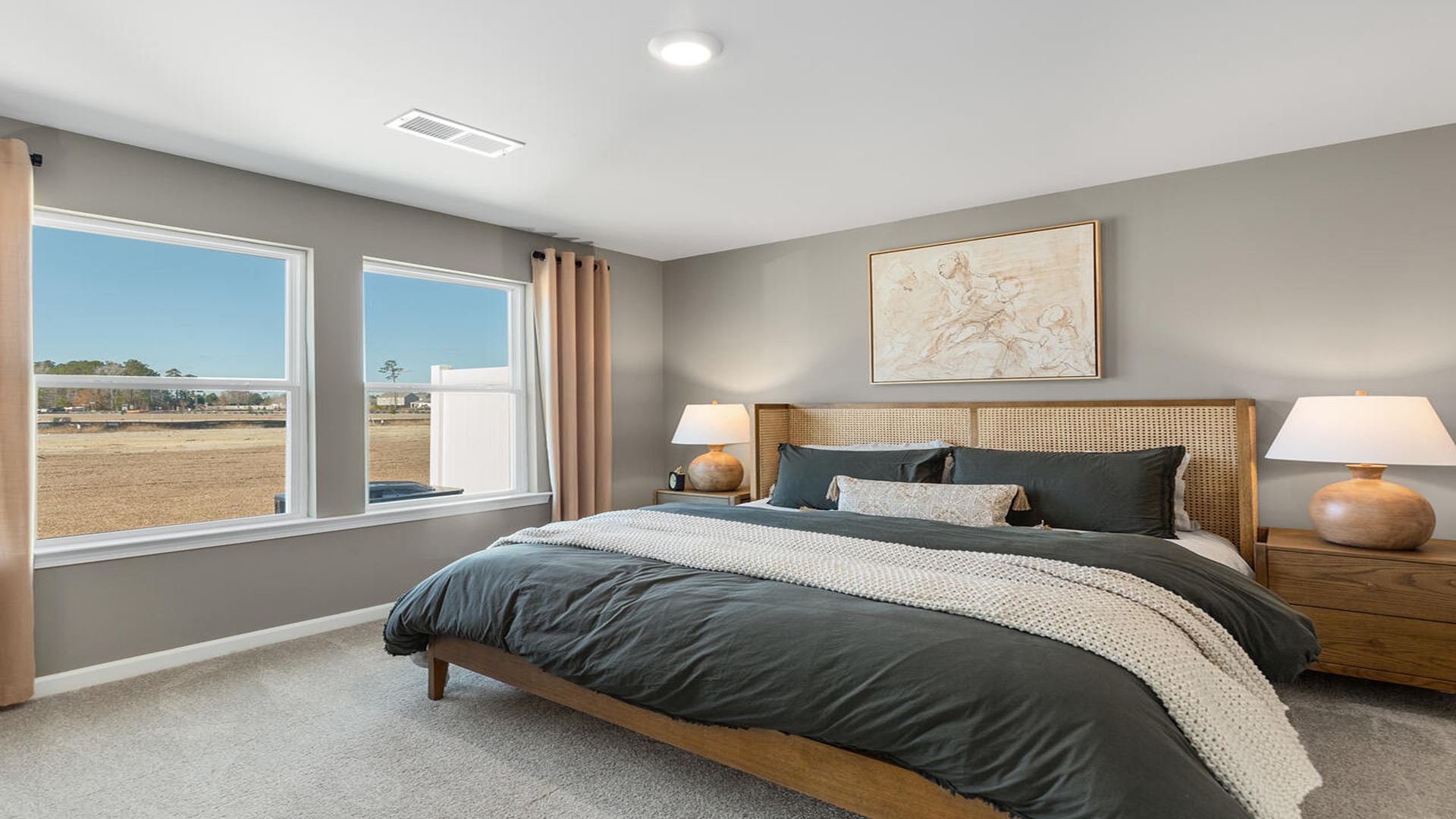 Primary bedroom with a bed and side table