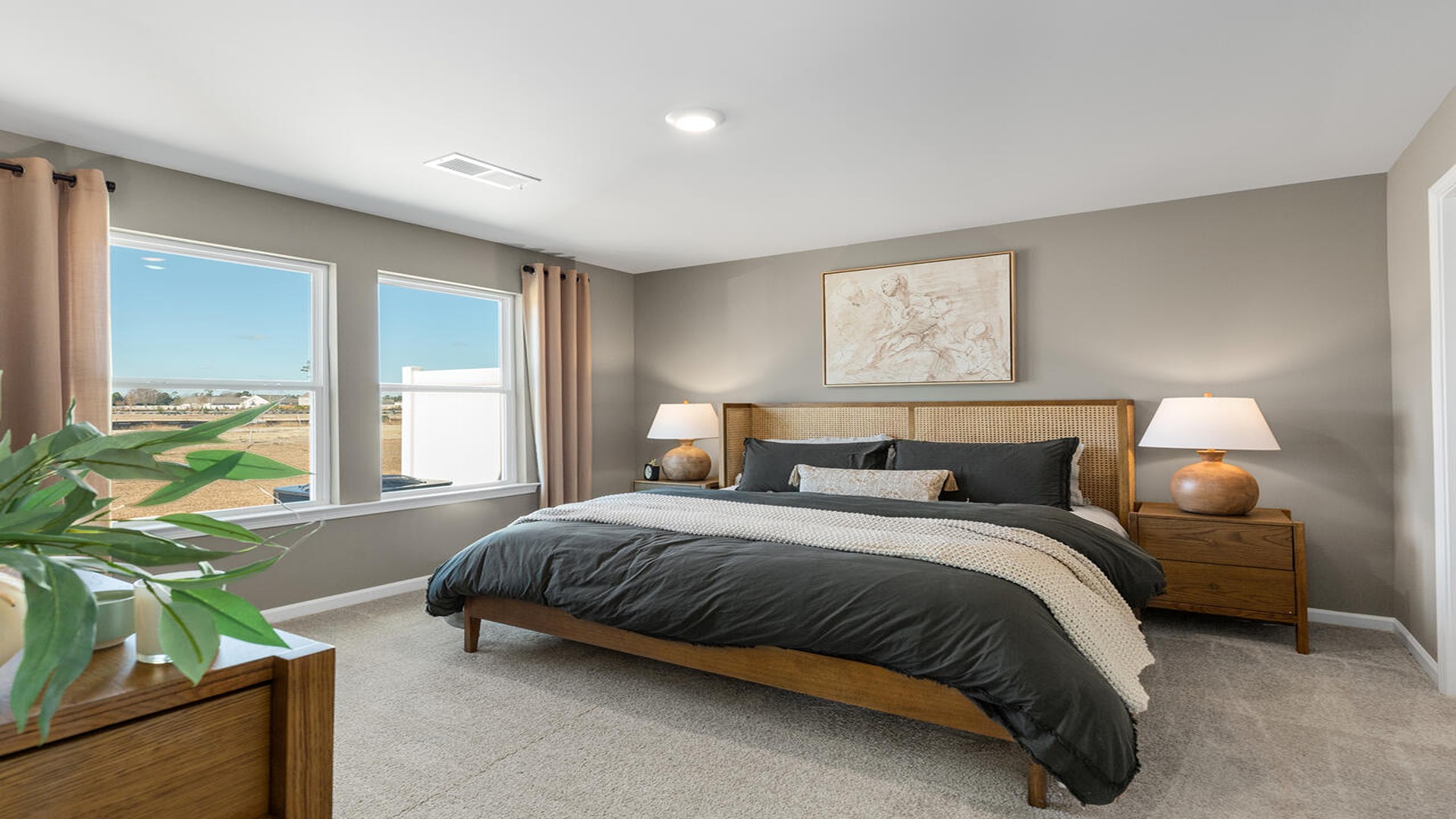 Primary bedroom with a bed and side table