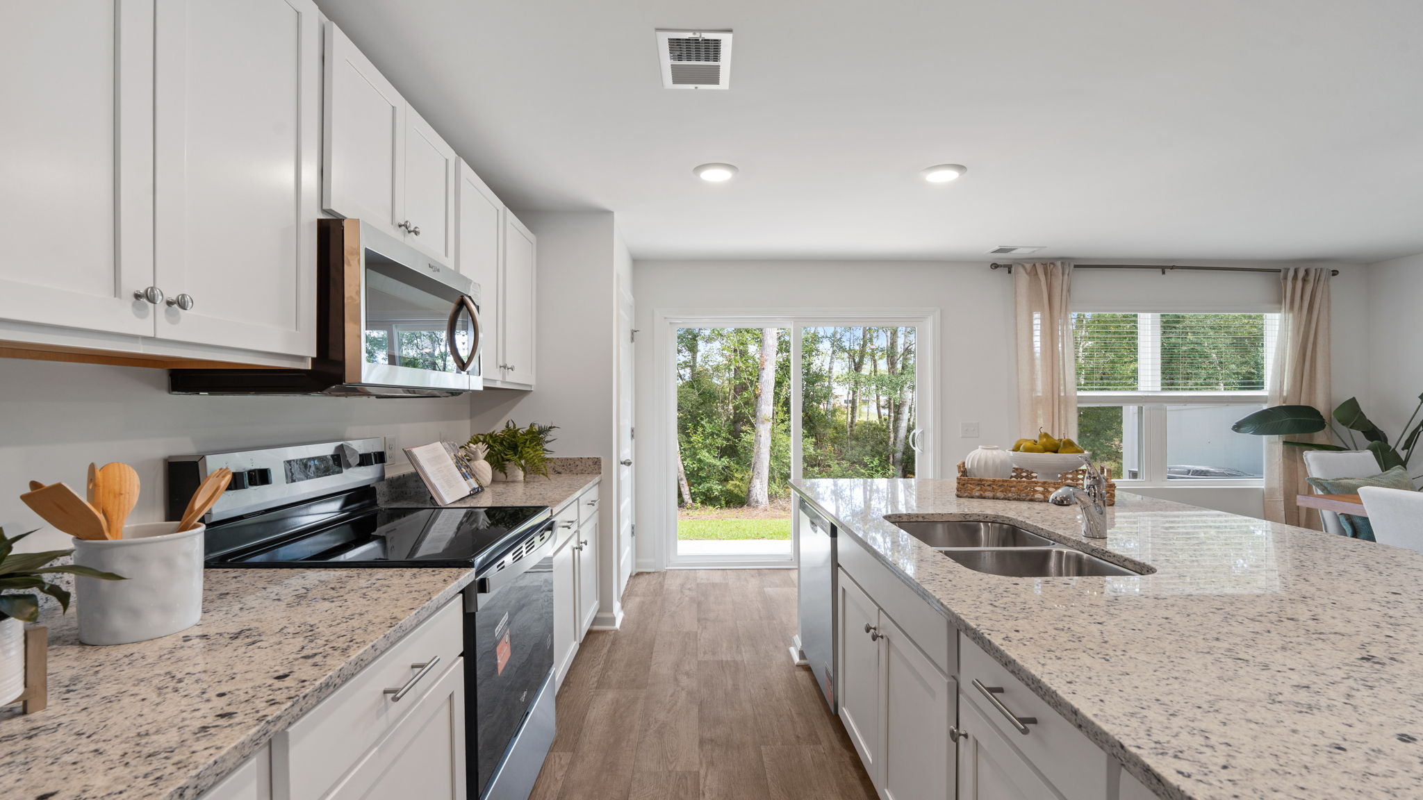 Spacious kitchen with granite countertops and open-concept design in the Denmark floor plan