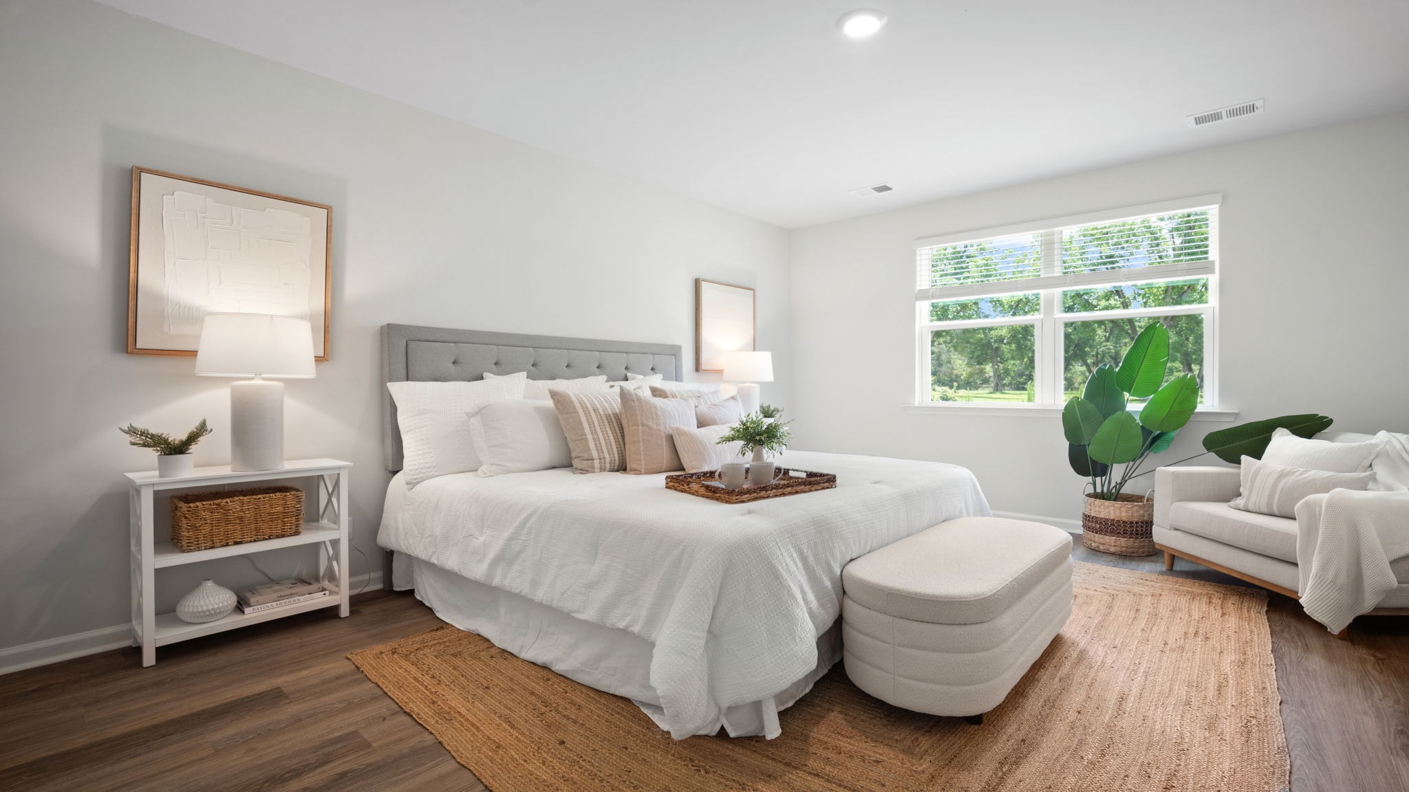 Primary bedroom with a bed and bench