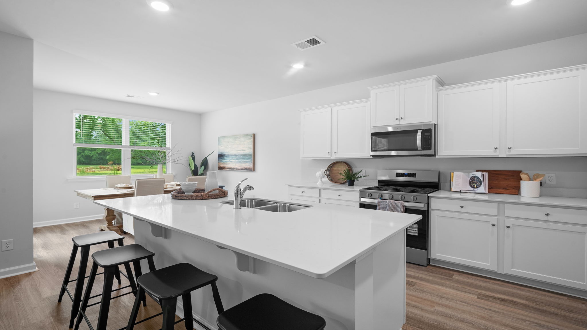 Oversized kitchen island serving as the heart of the Alston floor plan.