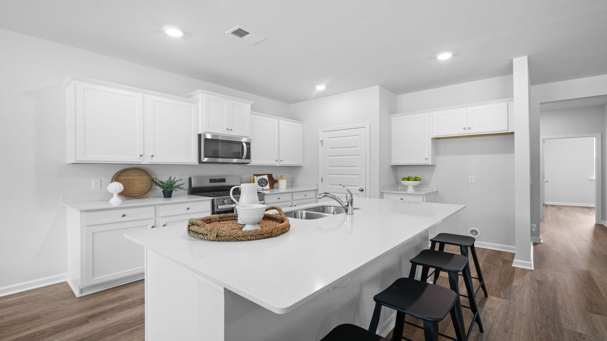 Large center island providing seating, meal preparation space, and additional storage.