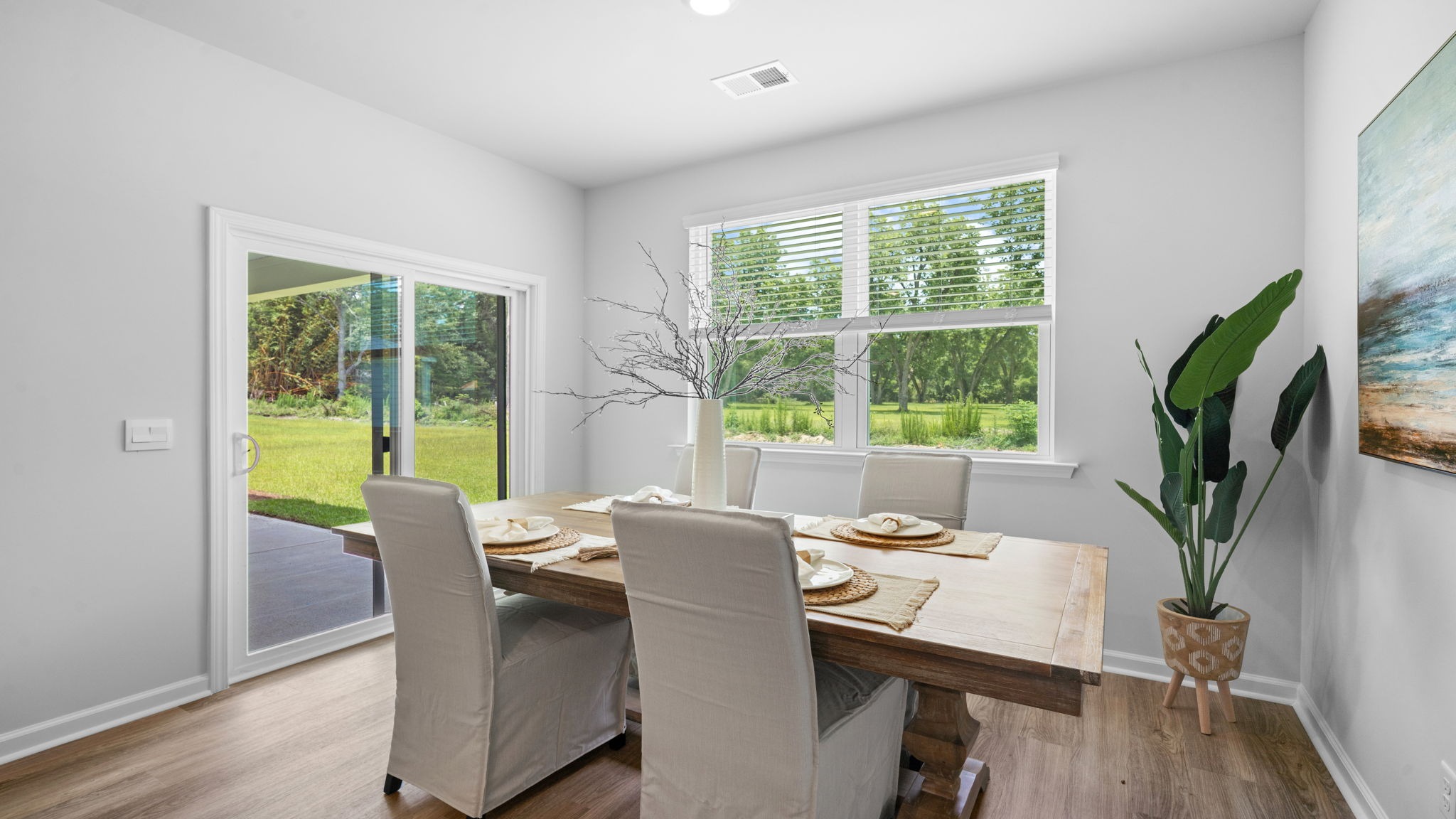 Open dining room filled with natural light and modern design elements.