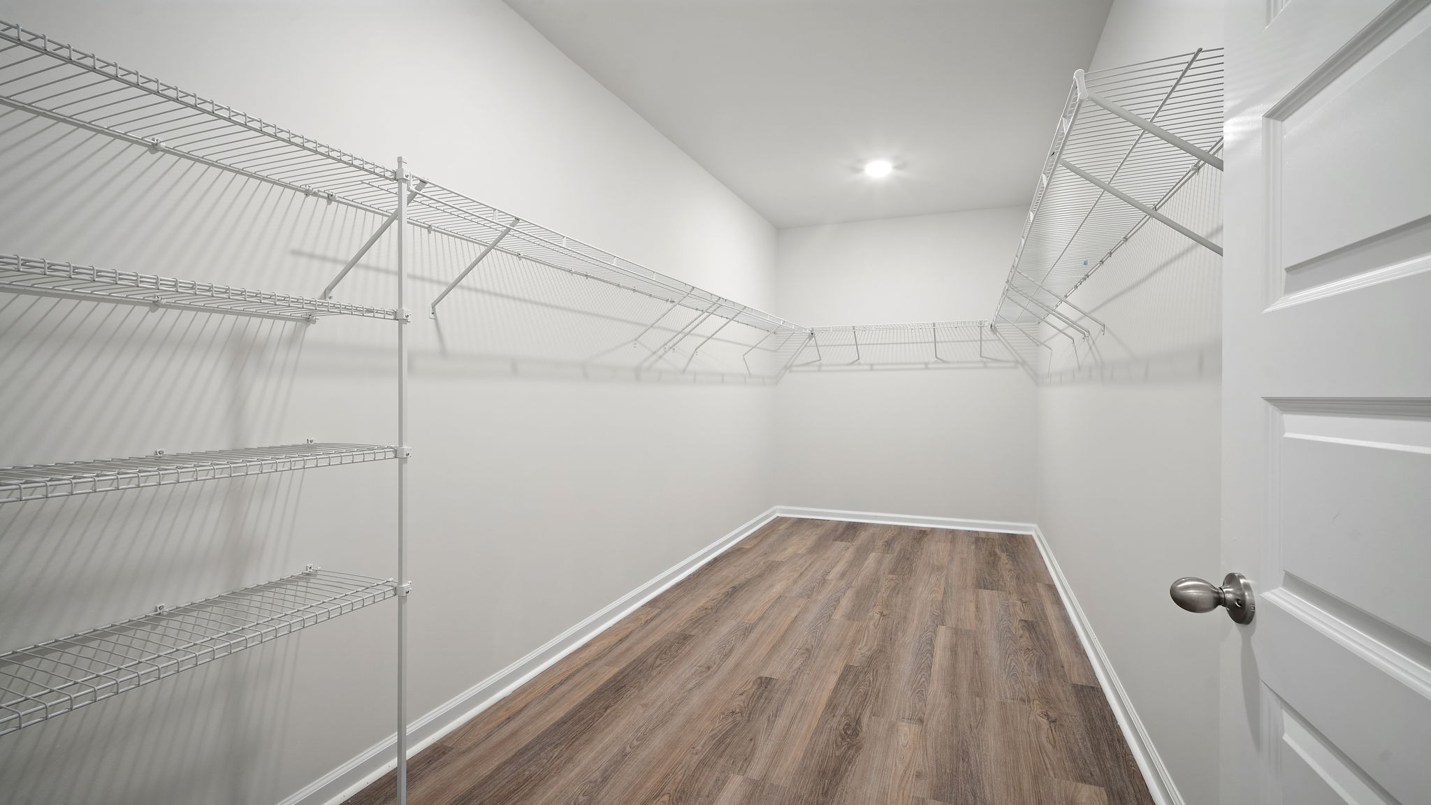 Expansive walk-in closet in the primary suite providing exceptional storage and organization.