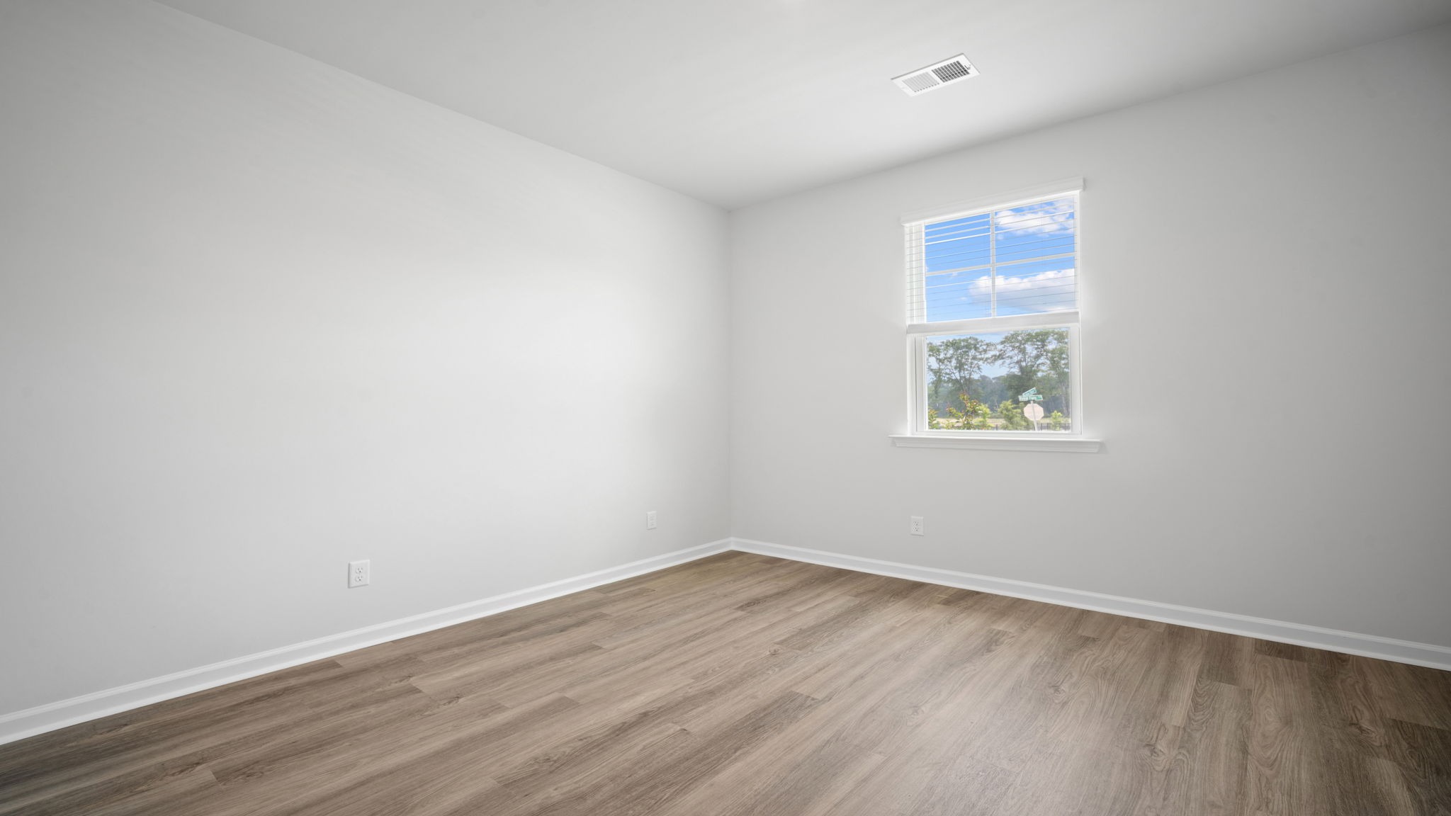 Bright guest bedroom with generous closet space and versatile functionality.