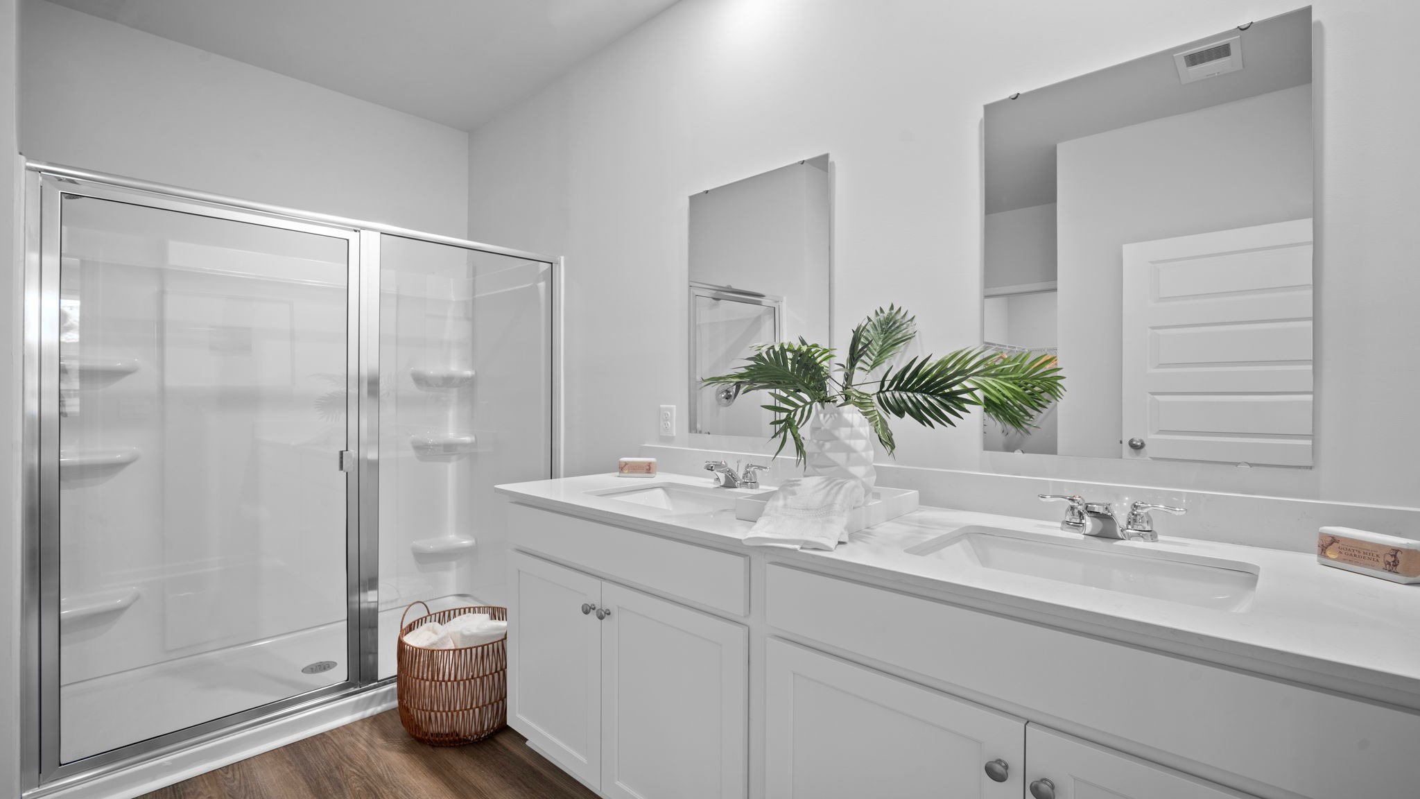 Primary bathroom with a stand-up shower and double vanities
