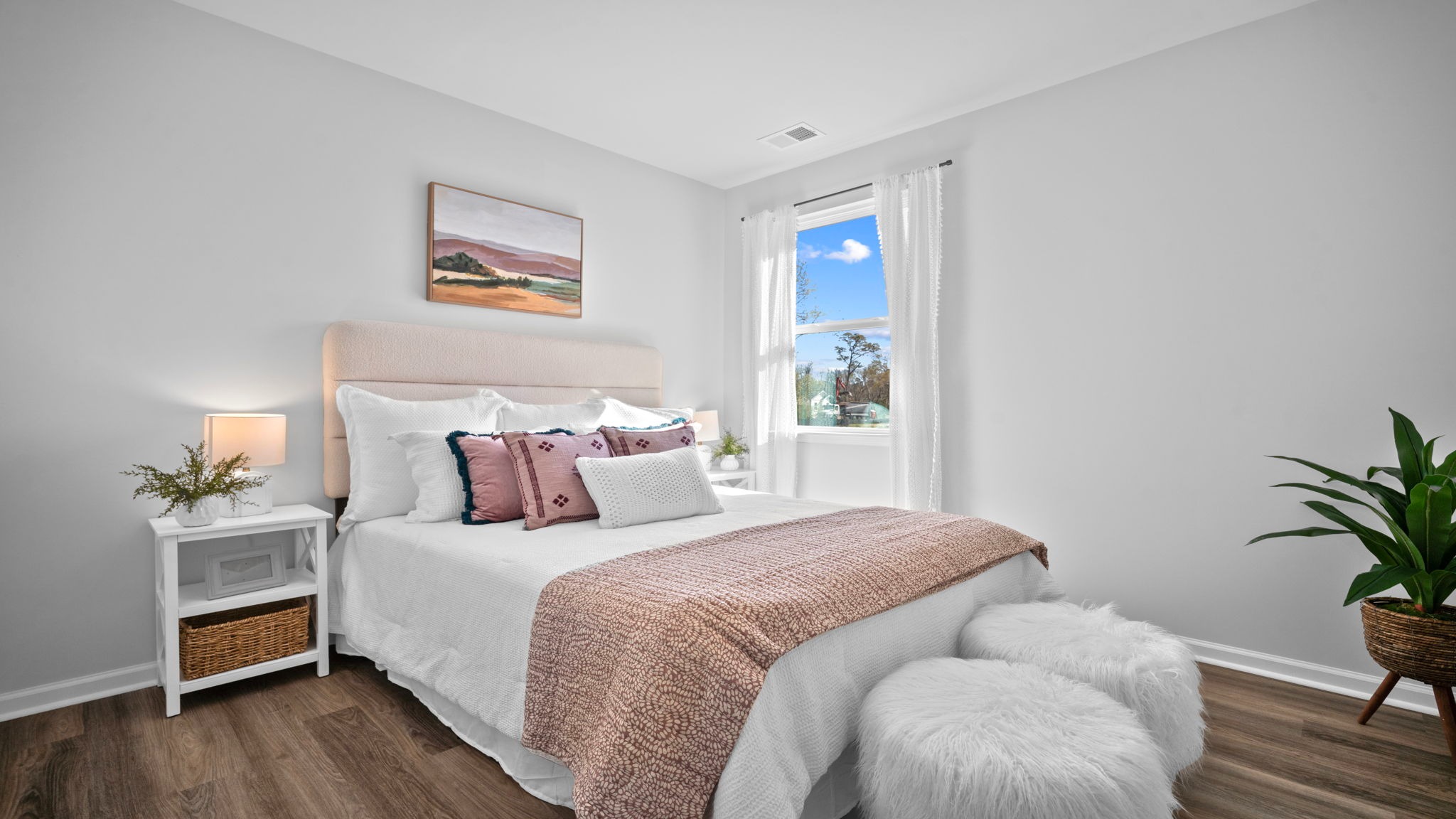 Guest bedroom decorated with a bed and side table