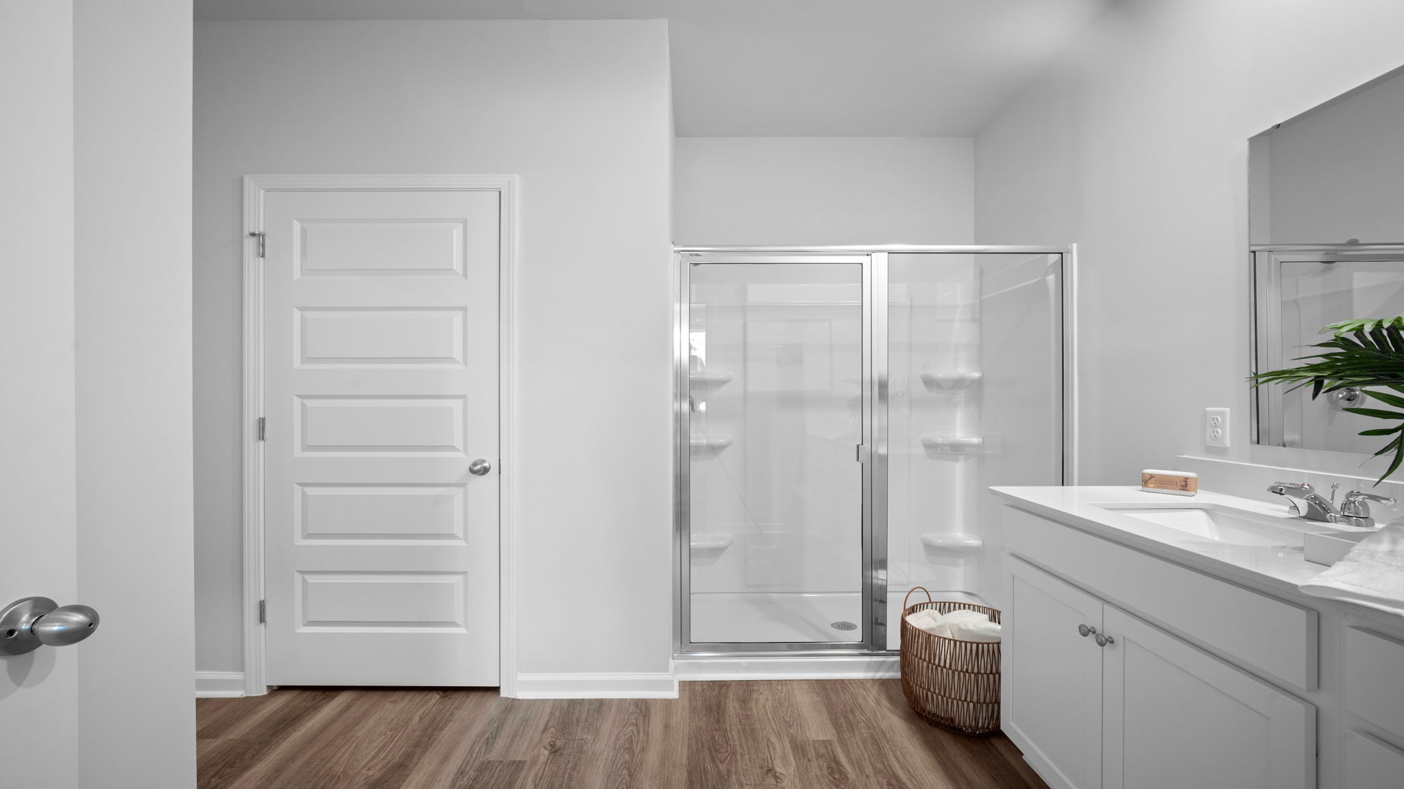 Owner’s bathroom with double vanity and walk-in shower in the Cali home