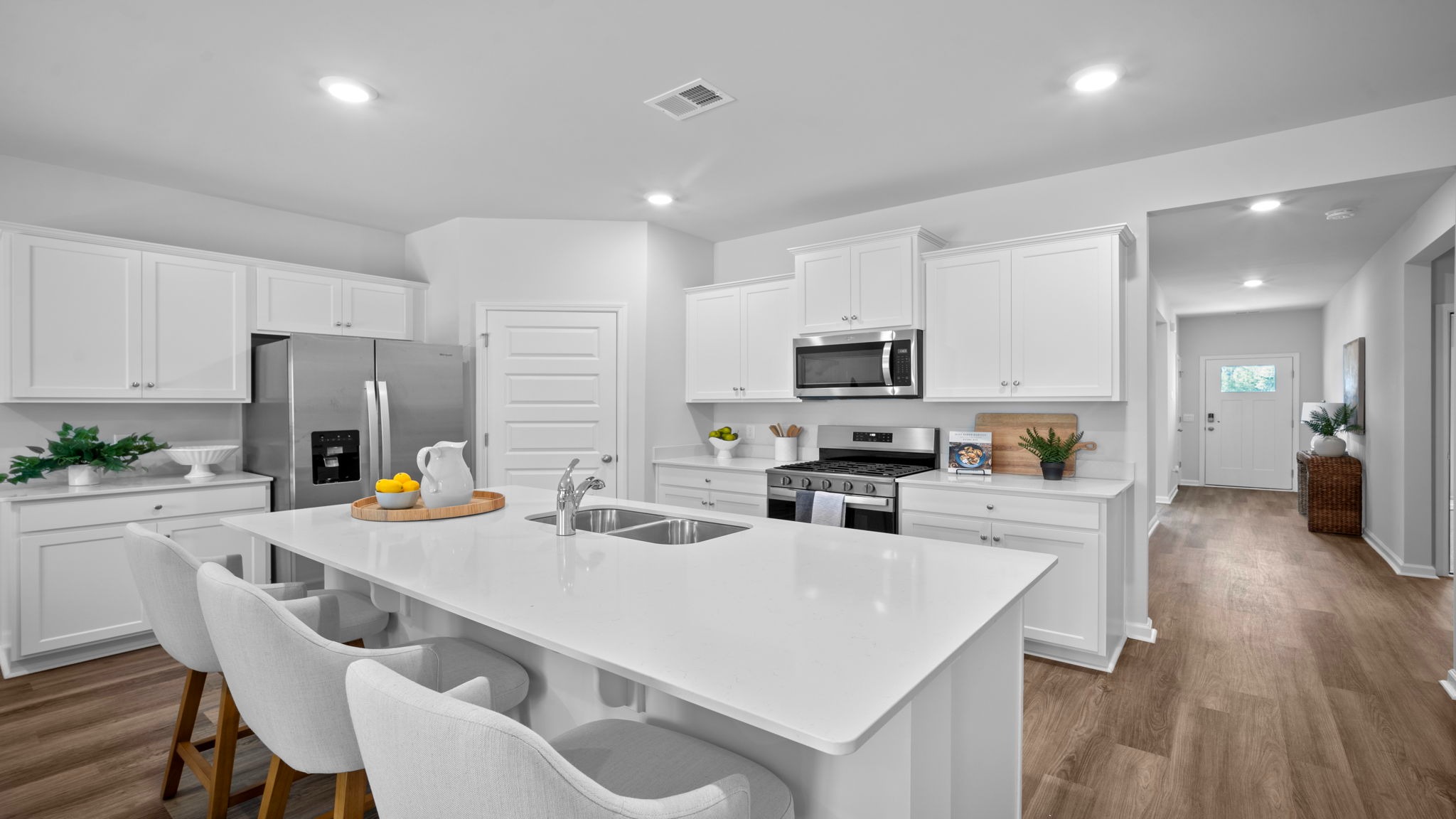 Gourmet kitchen with quartz countertops and center island in the Cali floor plan