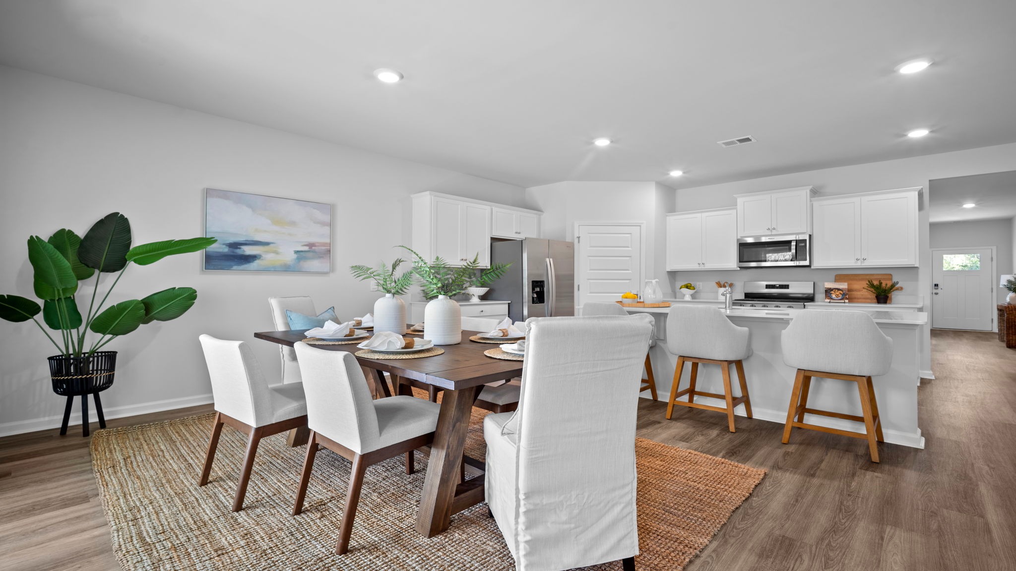 Dining area open to the kitchen and family room in the Cali home