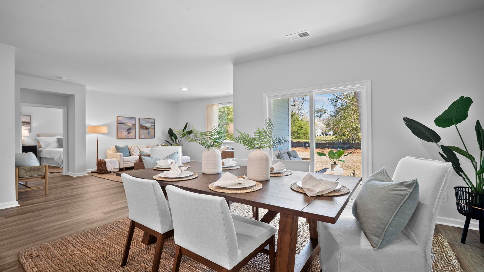 Dining room open to the kitchen and family room in the Cali floor plan